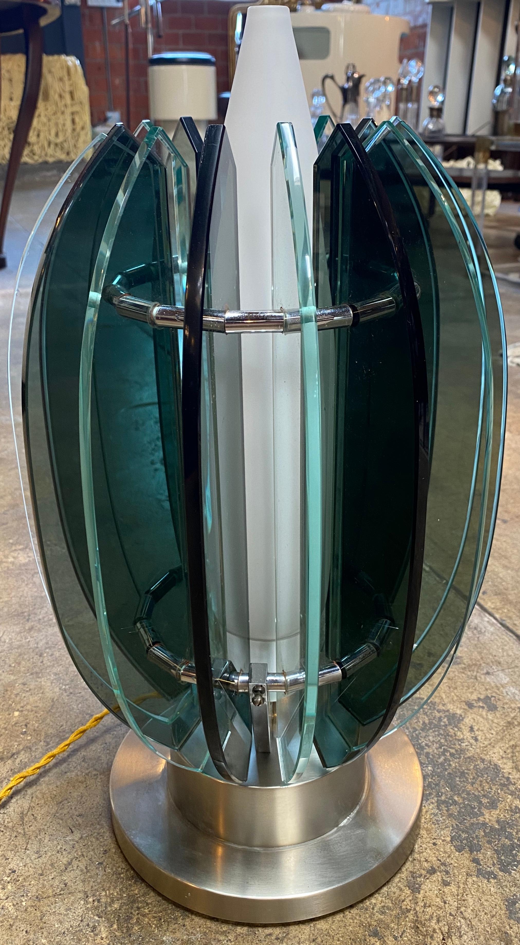 Stunning table lamp made with chrome base , opaline glass in the middle and 16 glass shade all around.
This piece is very unique and ultra rare.