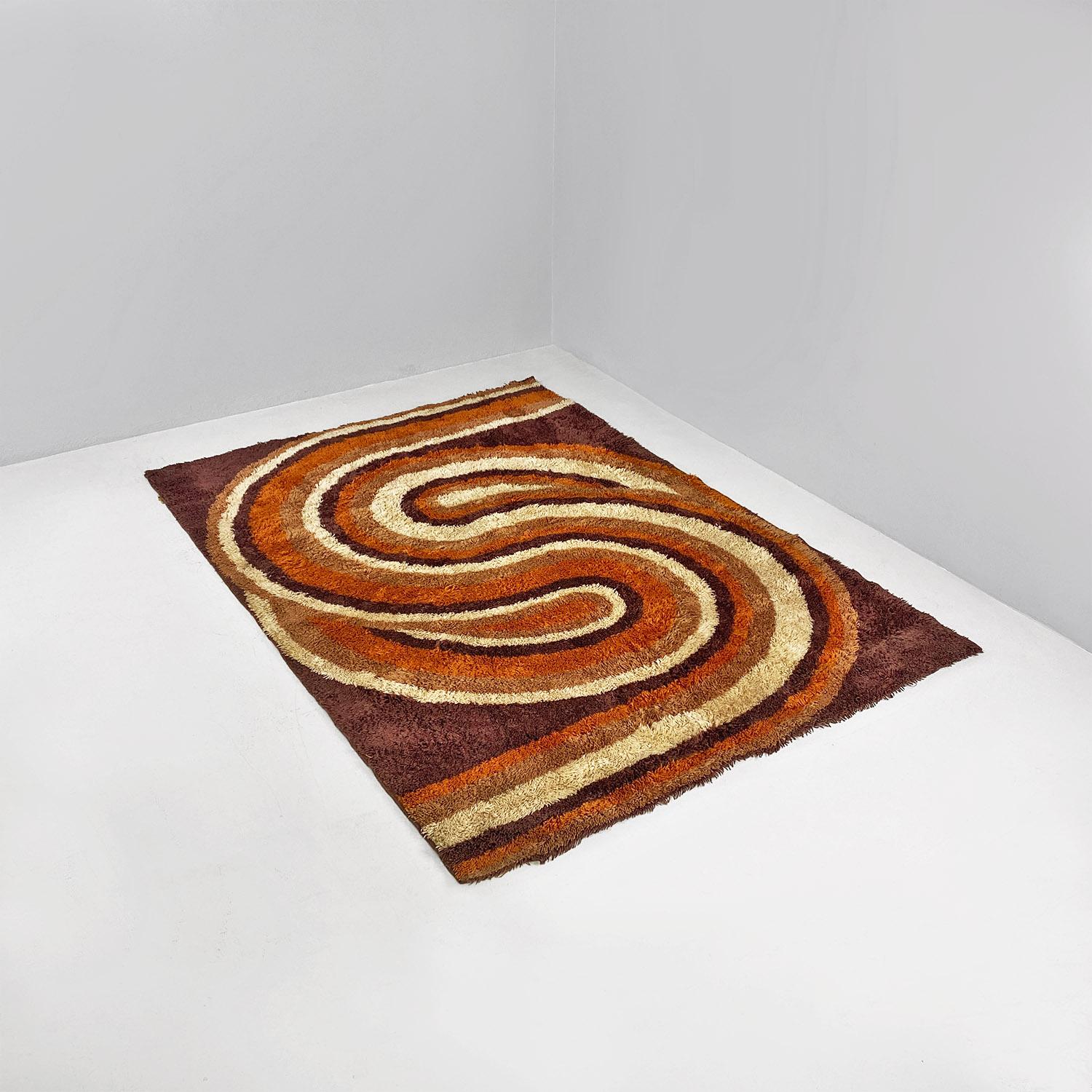 Tapis italien à poils courts de couleur marron, avec décoration orange et beige, datant de l'ère spatiale, 1970.
Tapis à poils courts de forme rectangulaire, avec un dessin sur fond brun foncé et un motif géométrique curviligne dans les tons de