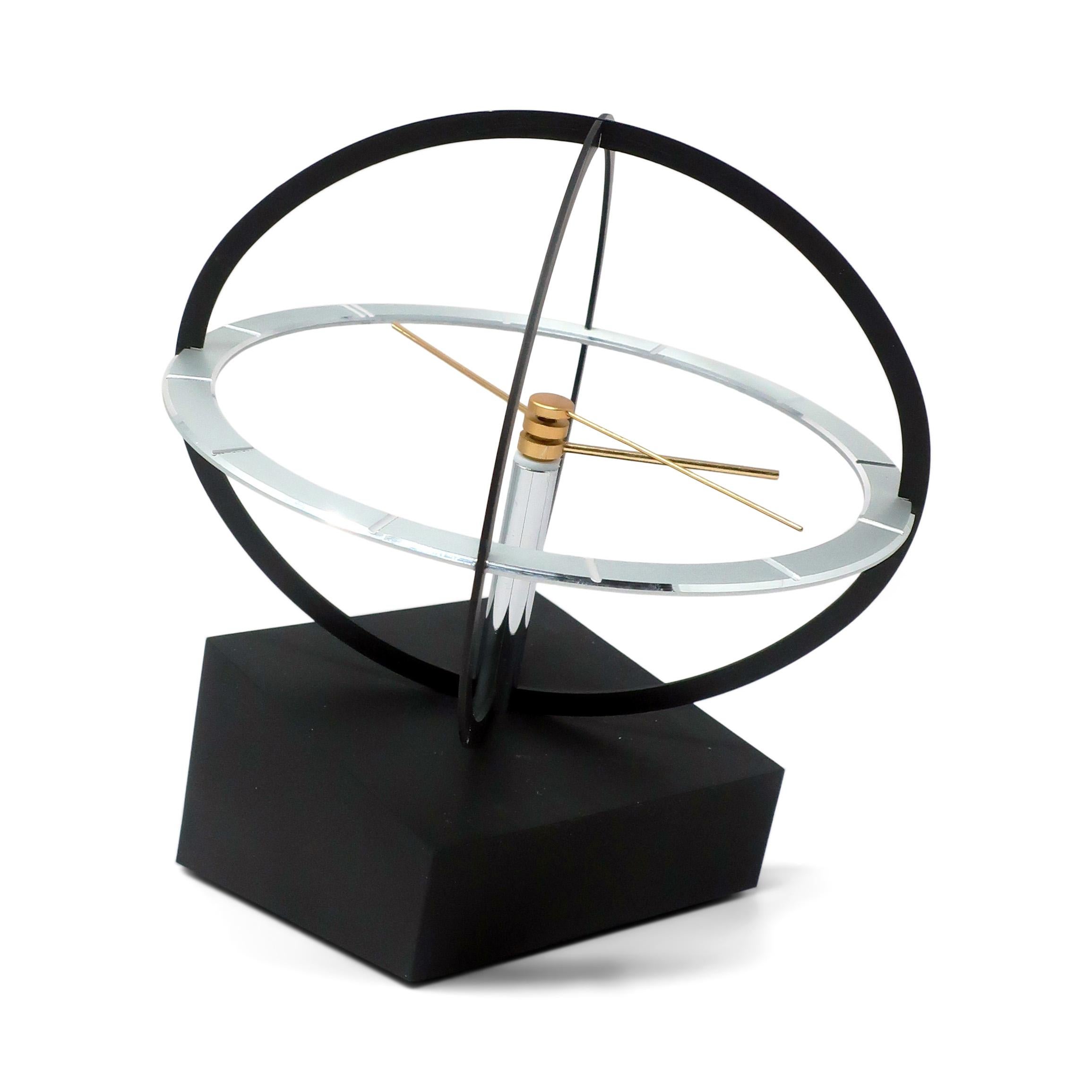 Bringing a touch of Space Age design flair to your space, this mid-century clock features a kinetic sphere design, with the clock's hands rotating within the chrome frame.  This clock was made or licensed by several companies (including 