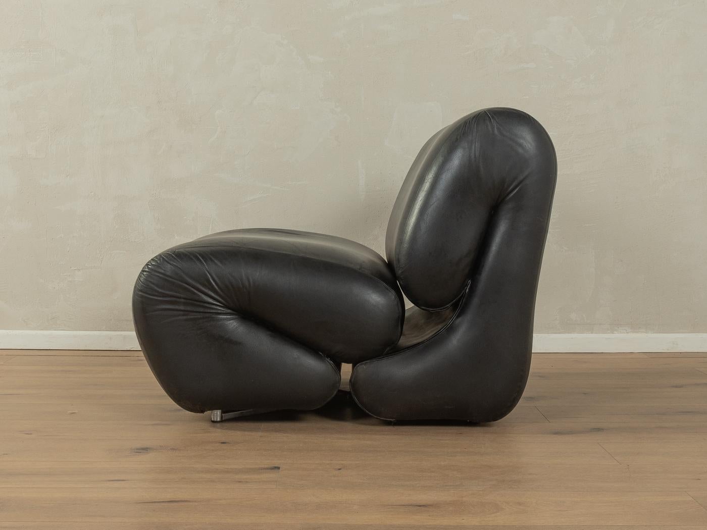 Unique Space Age armchair from the 1970s. High-quality padding with the original cover made of black leather and stainless steel legs.

Quality Features:
very good workmanship
high-quality materials
Made in Germany

Sitting height 38 cm