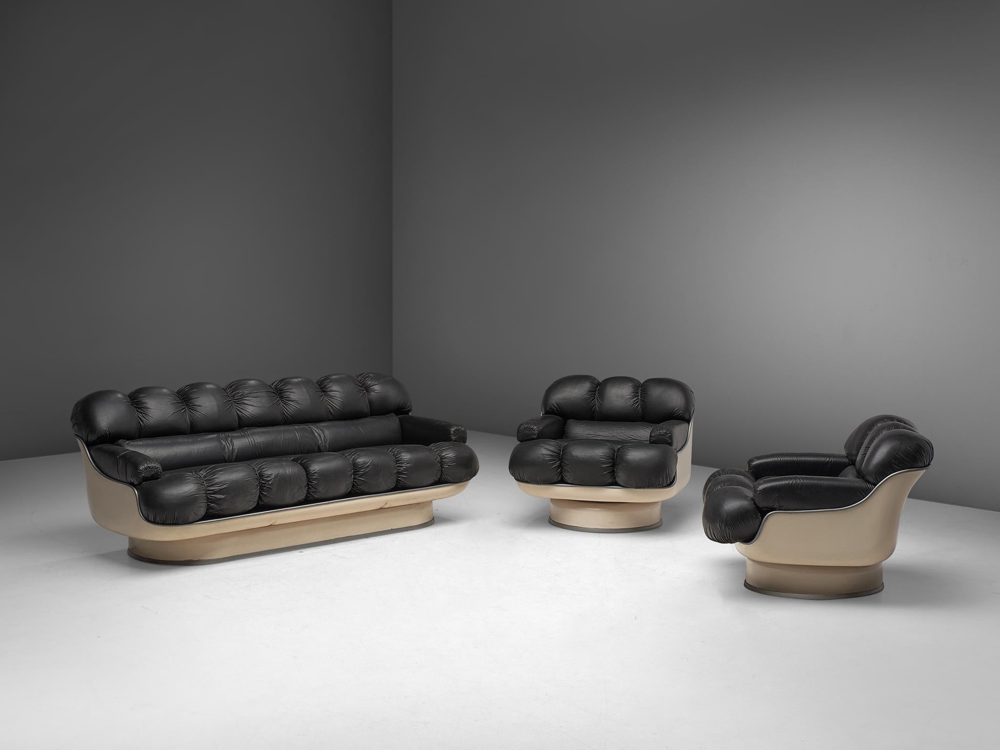 Lounge set, fiberglass and leatherette, France, late 1970s.

This highly comfortable living room set, consisting of one sofa and two lounge chairs, has a very soft and inviting appearance. Executed in off white fiberglass and black leatherette.