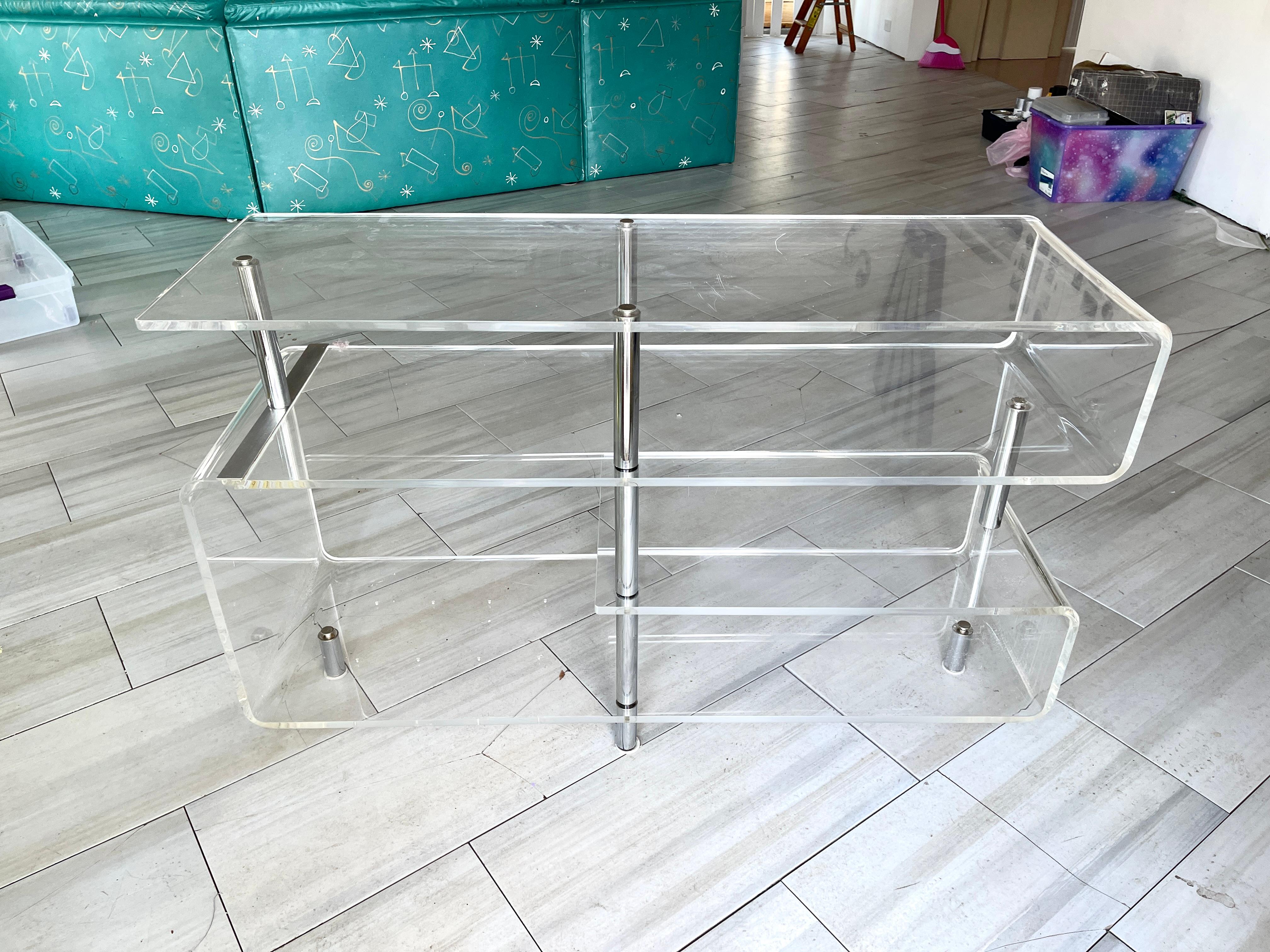 Space Age serpentine console table shelves with chrome supports.
Sufficiently robust to support multiple books or objet.
Very clean. No yellowing.