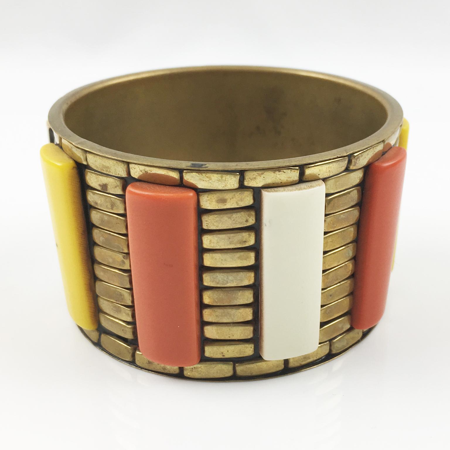 This stunning modernist bracelet features a chunky oversized bangle shape in carved gilded brass with large rectangular Lucite cabochons. Crafted from fine Lucite, the cabochons come in a beautiful assortment of colors including cream-white, yellow,