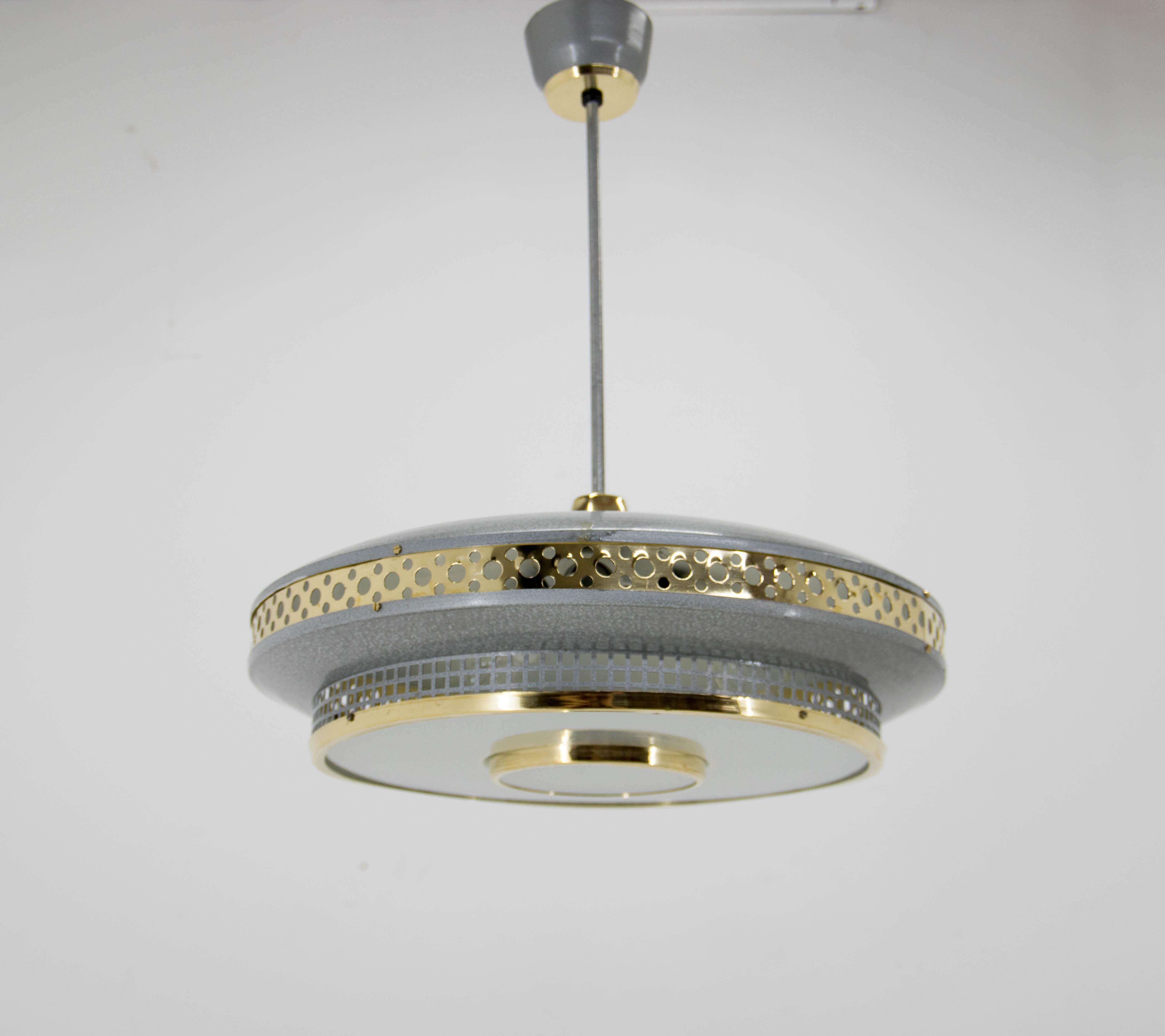 Metal ring pendant with brass perforated strip by LUDIB Bratislava, Czechoslovakia 1960's.
Perfect condition, restored: brass refinished, rewired - 3x60W, E25-E27 bulbs.
US wiring compatible.