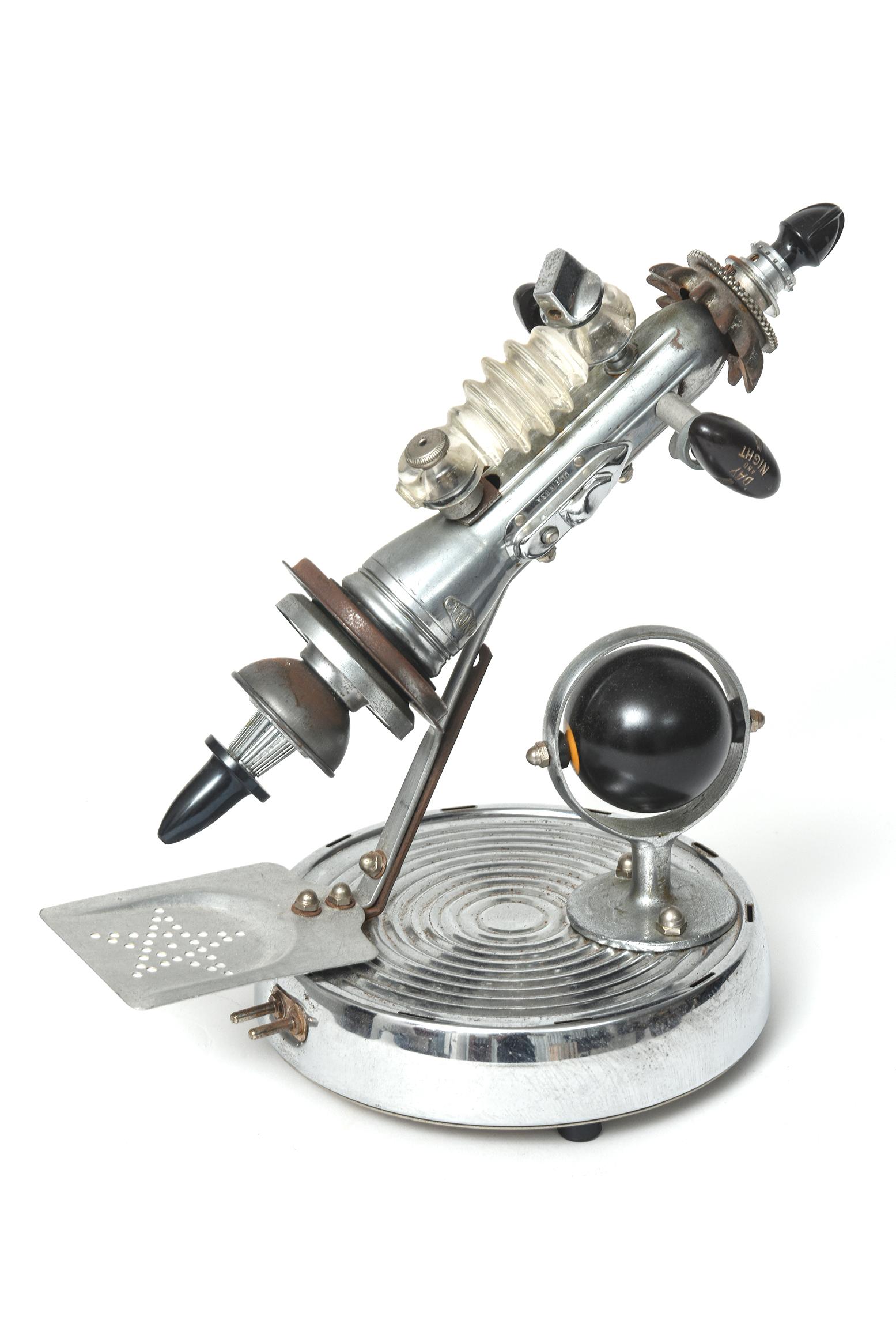 Metal space age rocket art sculpture titled VFR Zeta II by J. Bescant dated 10/2000. This extraordinary futuristic piece features a rocket leaving its launchpad and orbiting a planet. It was created completely from ordinary metal pieces such as a