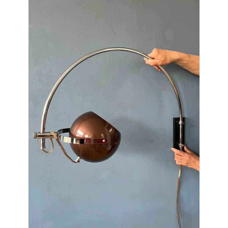 Rare arc wall lamp in sparkled brownish colour from the Dutch brand Herda. The shade can be turned any direction desirable and positioned inside or outside the arc. The lamp has a switch build into the cable. The lamp requires an E27 (standard)