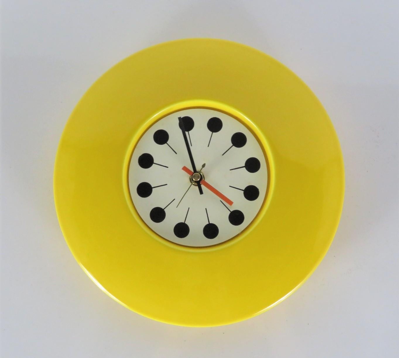 Space Age Mid-Century Modern ceramic wall clock from the 1960s. The clock has an UFO flying saucer shaped body and AA battery operated new clock movement matching the replaced old one. In perfect order, no issues. Very Pop with it's yellow, black