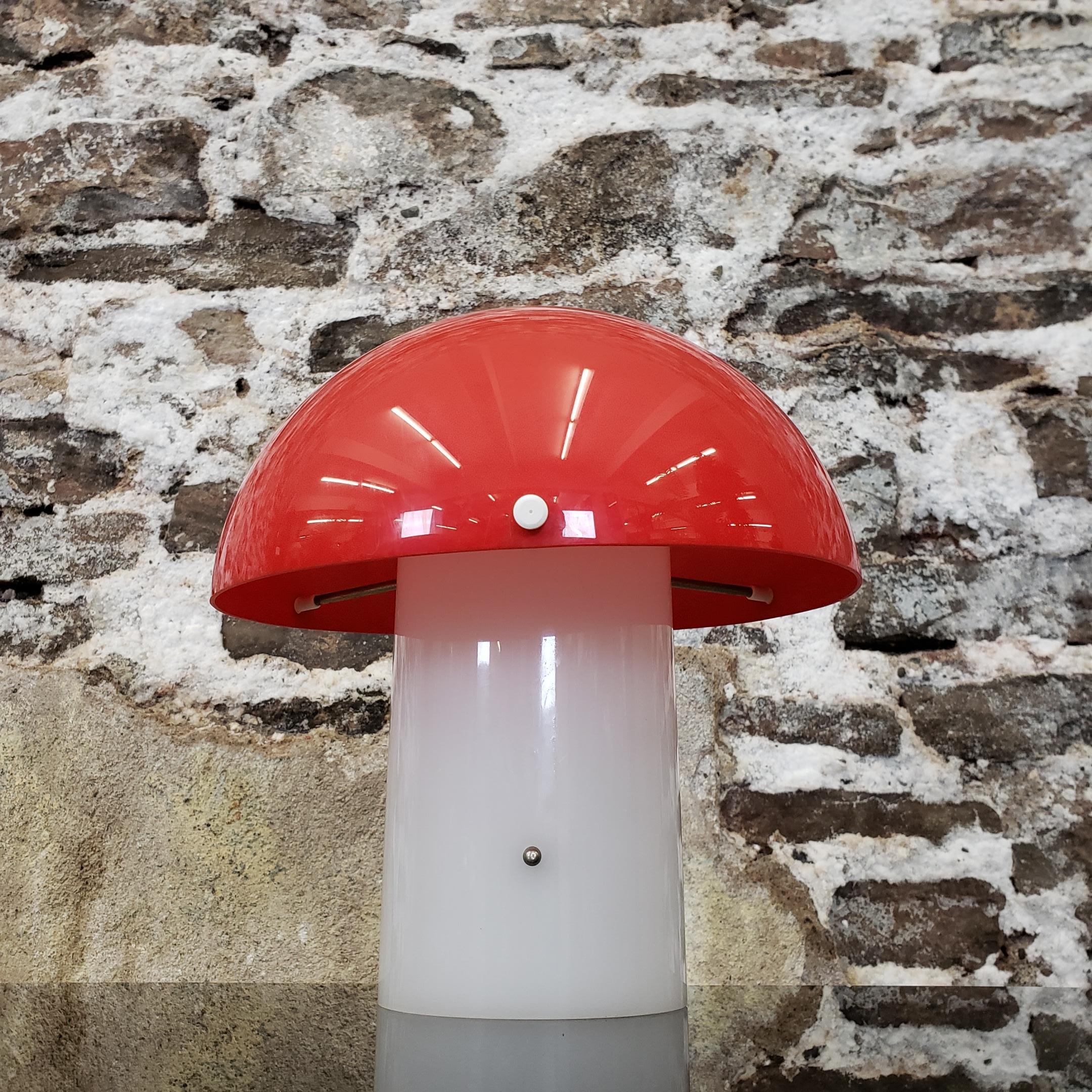 Space Age mushroom lamp with bright red shade and white base.