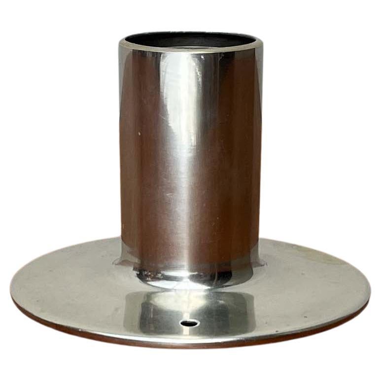 Simple Space Age table or wall lamp.

The lamp body is made of a single piece of aluminum. The shaft transitions harmoniously into a plate base. In order to be able to use the lamp as a wall lamp, the previous owner customized it and drilled a hole