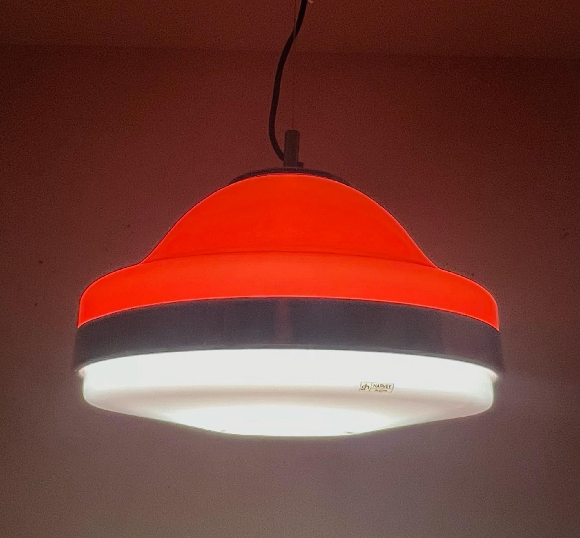 Beautiful and rare space age hanging lamp designed and manufactured by produced by Harvey Guzzini in the 60s/70s.

This avant-garde pendant light features the iconic orange and white acrylic lampshade - with the shiny chrome ring, lid and bezel