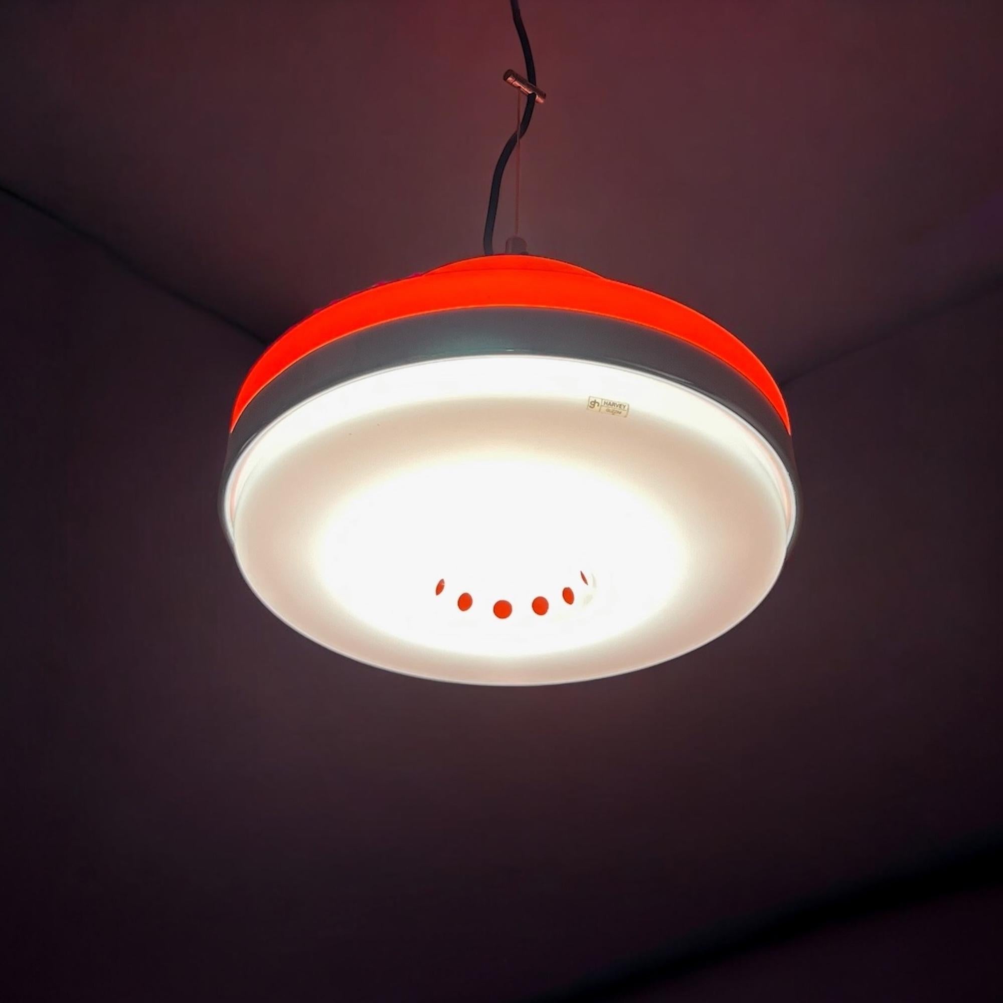 Beautiful and rare space age hanging lamp designed and manufactured by produced by Harvey Guzzini in the 60s/70s.

This avant-garde pendant light features the iconic orange and white acrylic lampshade - with the shiny chrome ring, lid and bezel