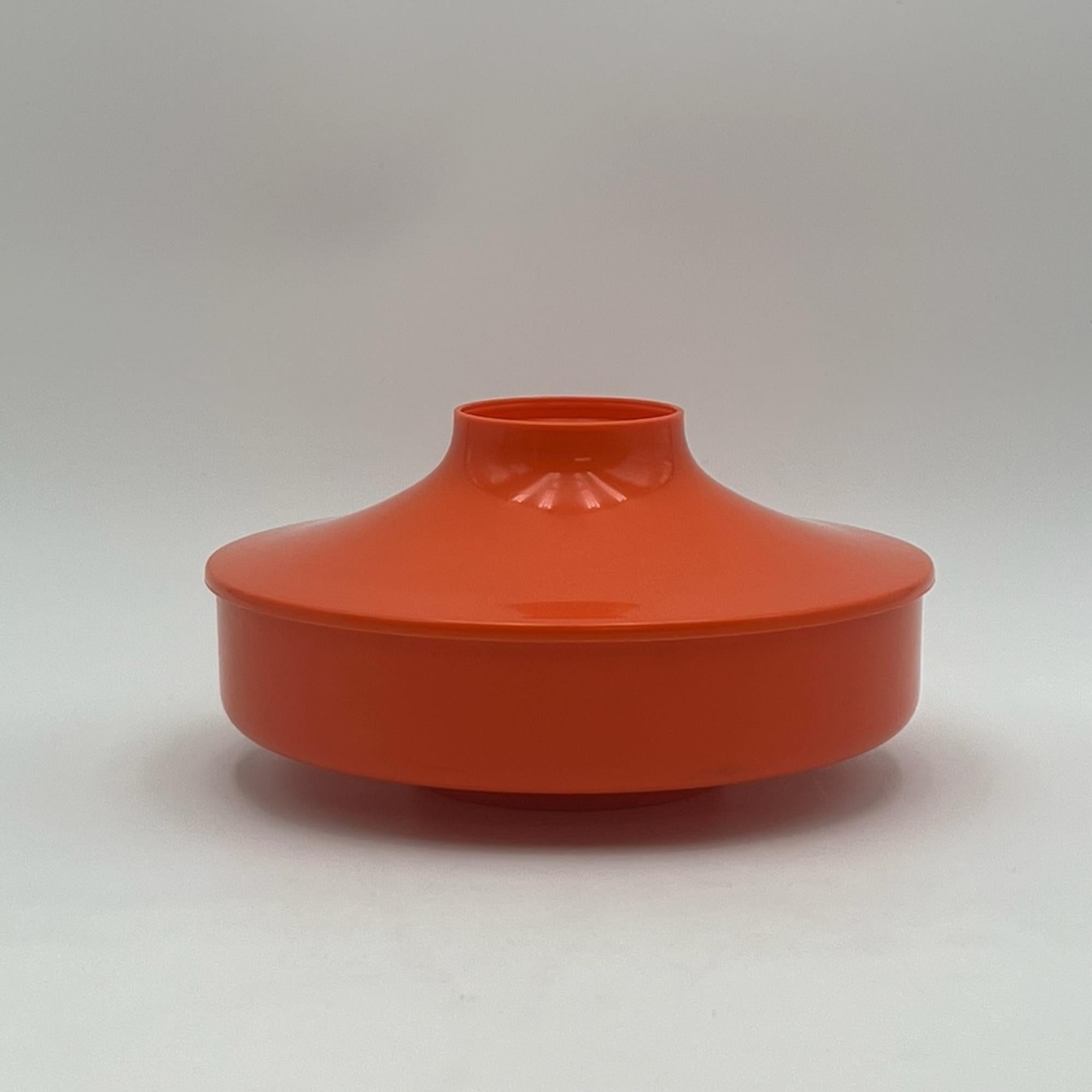 Iconic space age plastic jar designed by Luigi Massoni for Guzzini. 

This flying saucer shaped jar was produced by Guzzini for the renowned chocolate factory Venchi, founded in Turin in 1878.

The bright orange hue, the UFO-like shape and the