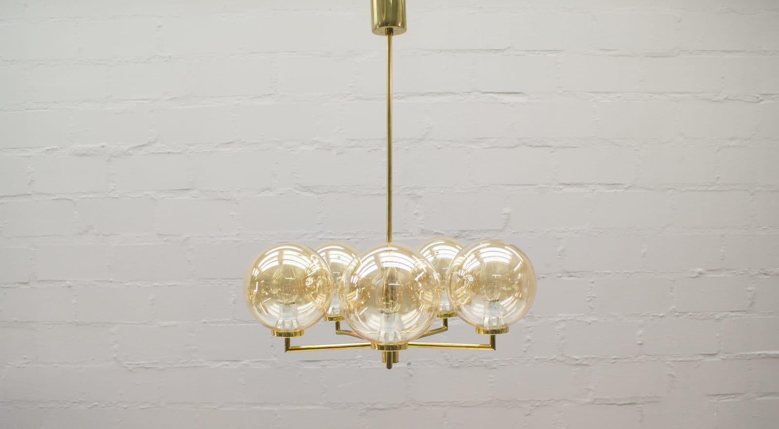 Elegant Mid-Century Modern chandelier. 

Executed in massive brass. The chandelier needs 5 x E14 Edison screw fit bulb.

They are wired, in working condition and run both on 110 / 230 volt.