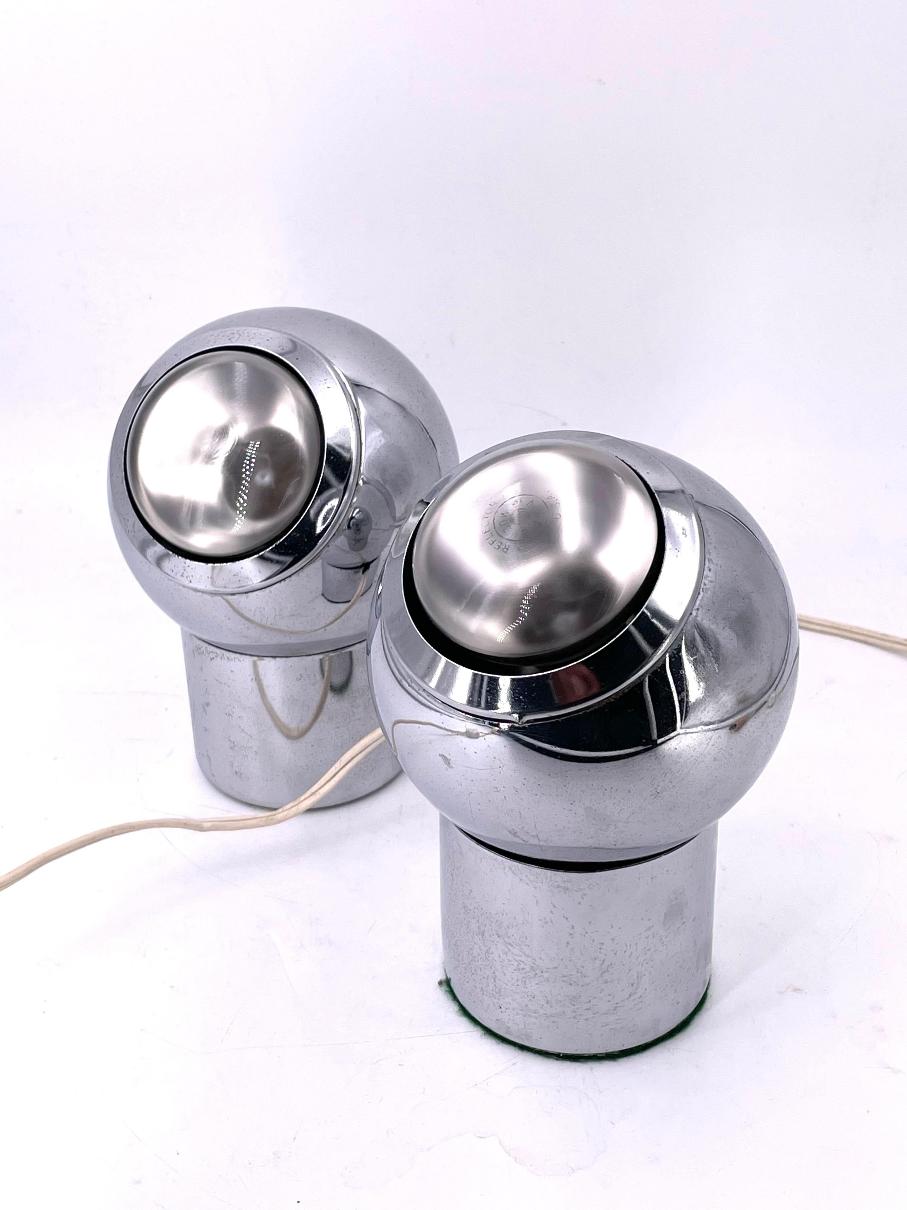 Rare pair of Space-age table lamps circa 1970's in chrome finish perfectly working condition the base it's magnetic and you can drill it to a wall and move it into any position you want.