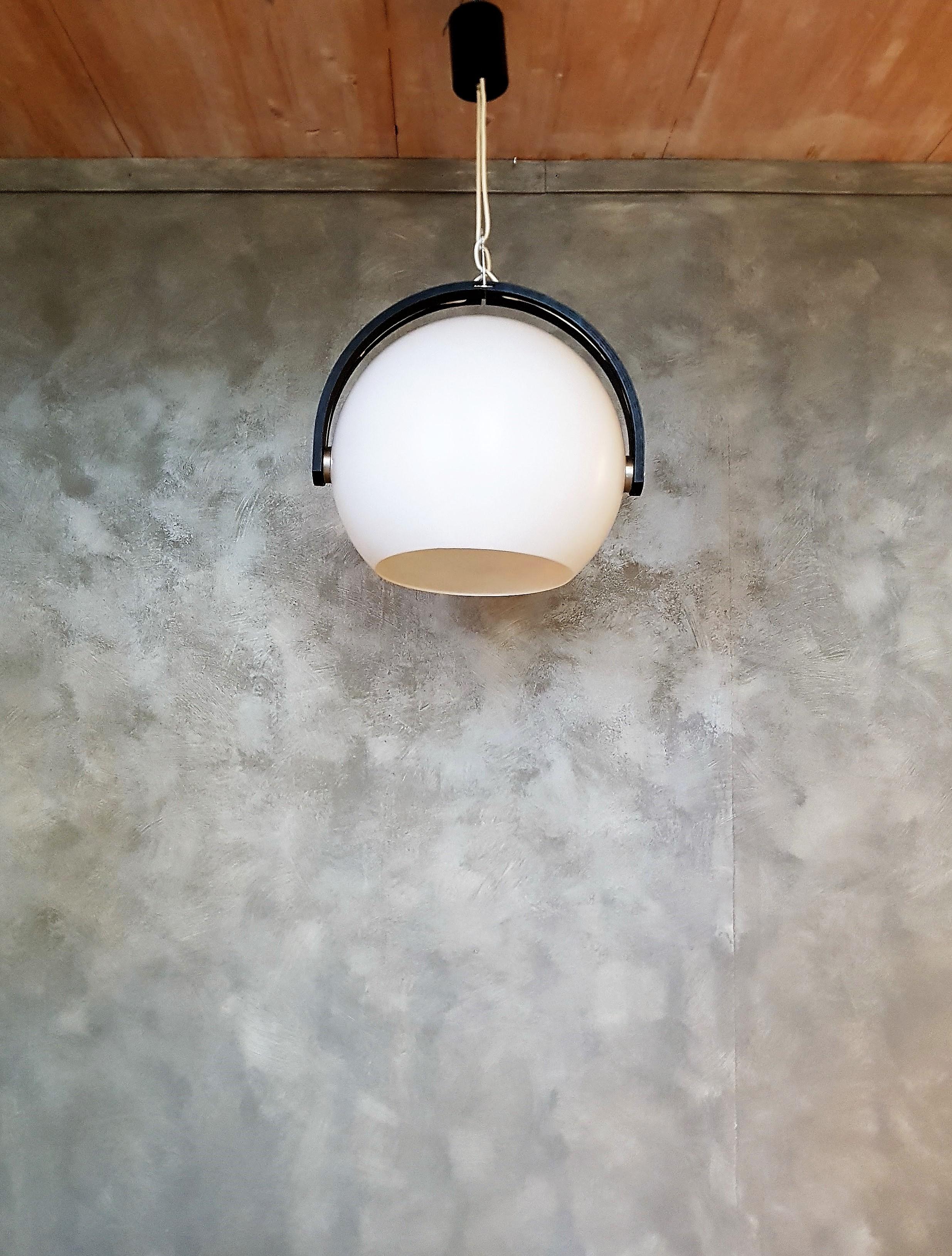 Space Age hanging lamp by Temde-Leuchten, white spherical reflector made of plastic and black laminated wood ring. The reflector rotates in the wooden bracket.