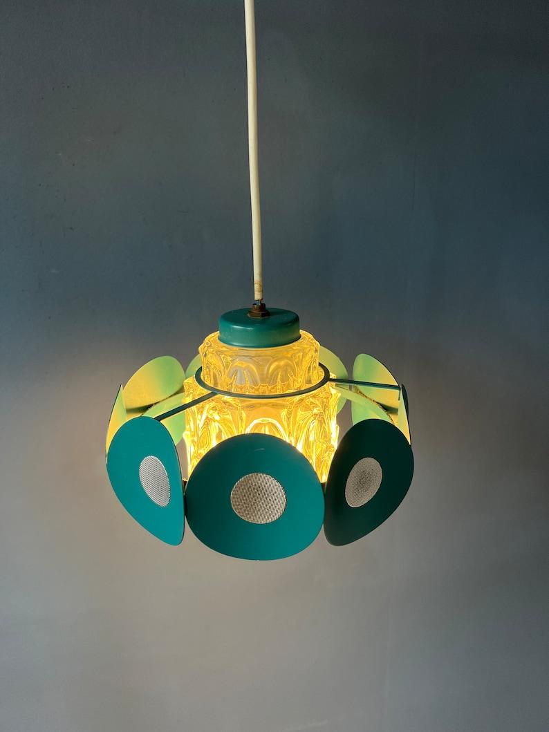 One of a kind space age pendant lamp with crystal glass shade and turquoise metal frame. The lamp produces a beautiful, crystal-like light. The lamp requires an E27/26 (standard) lightbulb.

Additional information:
Materials: Glass, metal
Period: