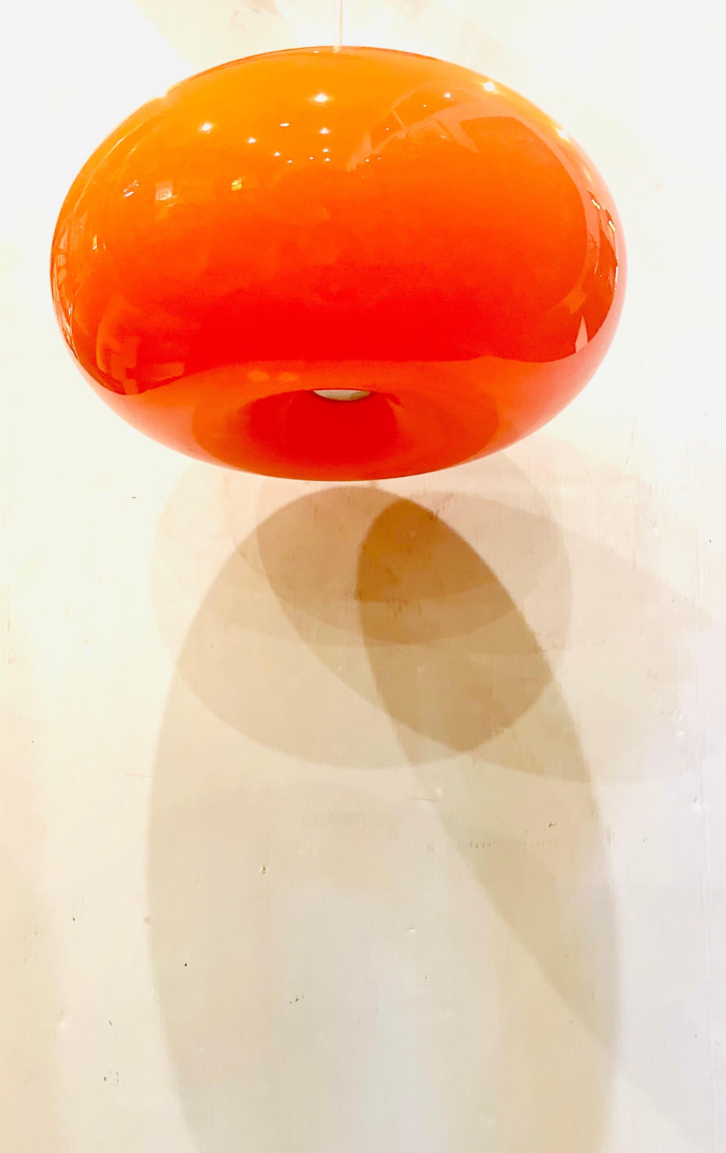 Incredible and rare orange glass, donut lamp freshly rewired can be used as a plug-in or hard-wired, circa 1970's excellent condition brings a unique glow when lighted.