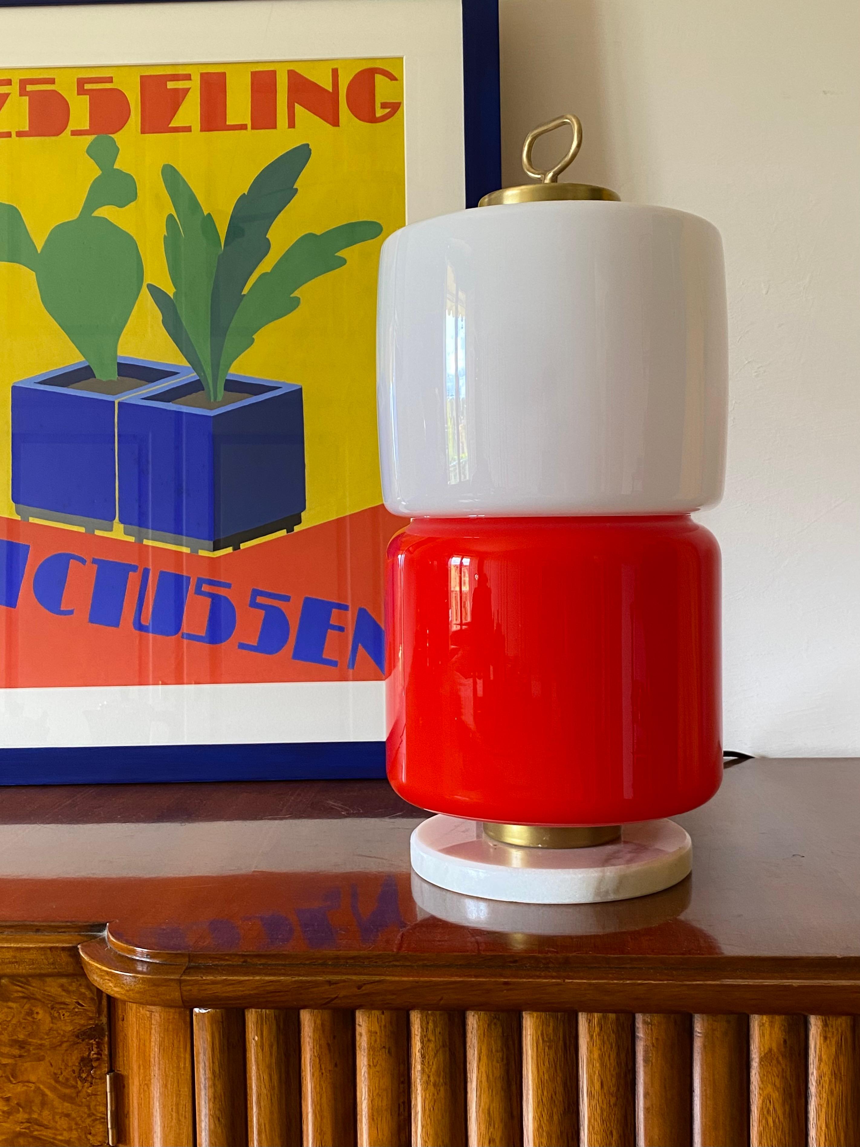 Space Age Murano glass table lamp.

Stilnovo, Italy 1970s

White and red glass. Brass, white marble base. Two bulbs.

48 cm H - 22 cm diam.

Conditions: excellent, no defects