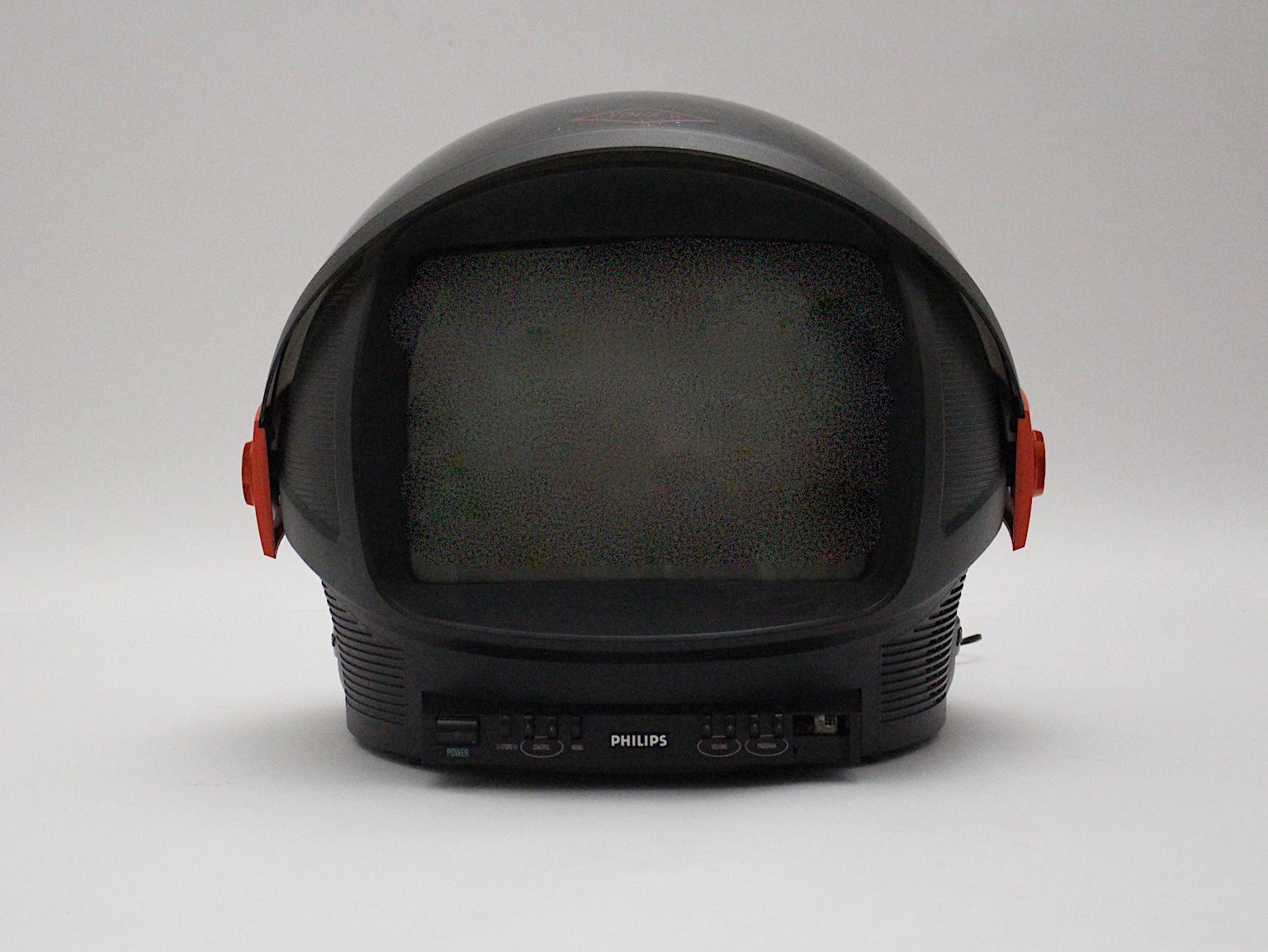  Space Age vintage red and plastic television named discoverer, which was manufactured by Philips, Netherlands, 1980s.
Its outstanding shape makes this design piece so fascinating.
The case of the television is foldable and looks like a helmet.
It