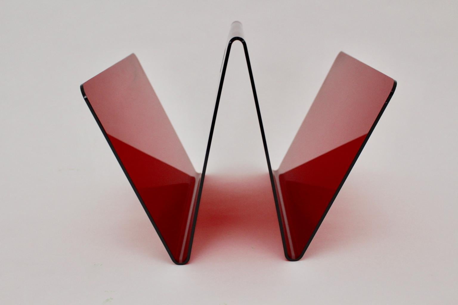 Space Age red vintage magazine rack from plastic designed and made circa 1970. The magazine rack features two compartments for the newspapers. Also it shows a handle for an easy handling.
The vintage condition is very good with minor signs of age