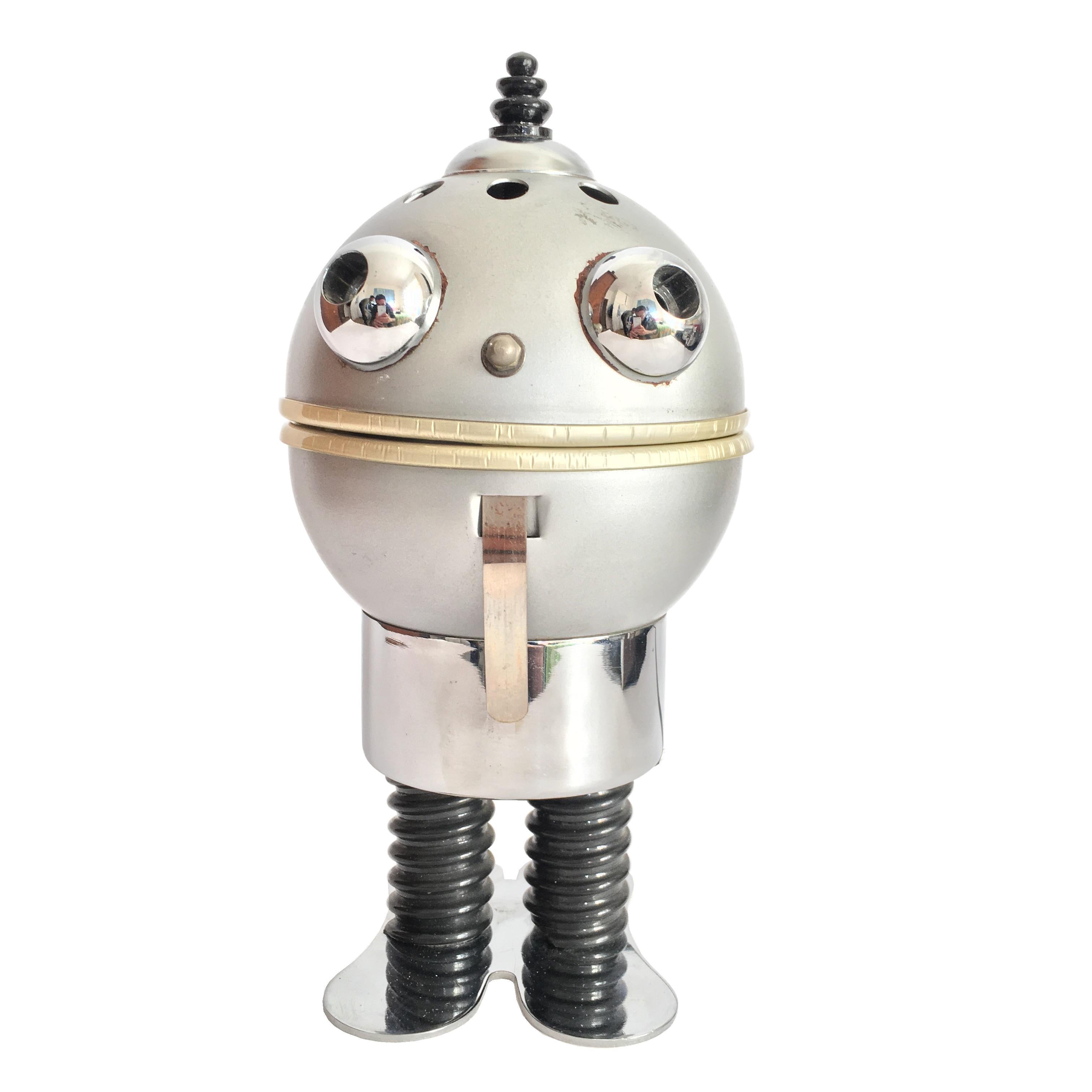 This adorable little robot lamp from the Space Age (1970s) is made of chrome and aluminium. The light came from its mouth: it makes more or less light depending on the opening of the mouth.