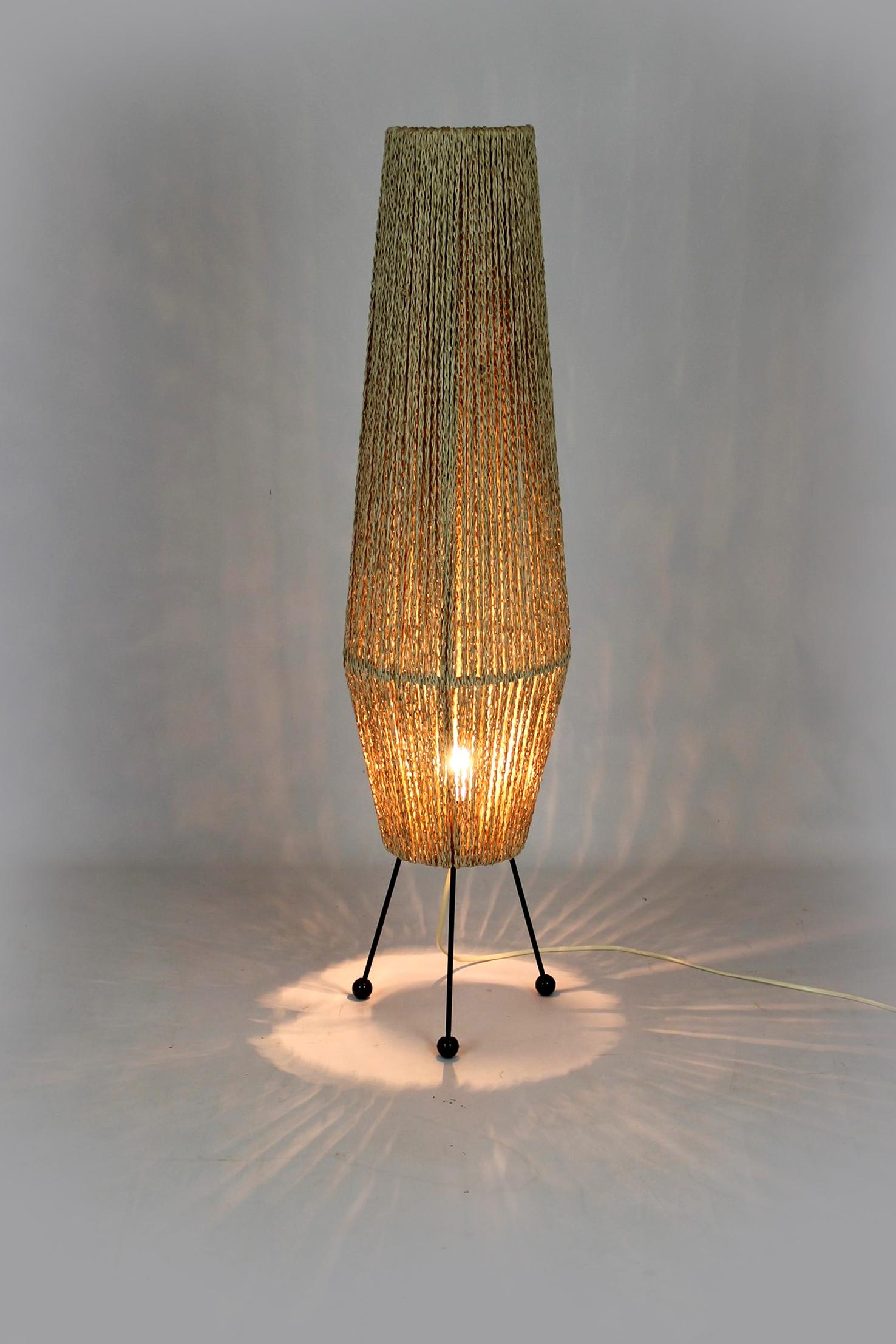This floor lamp in the Space-Age style was manufactured in Czechoslovakia in the 1960s. The lamp stands on three steel legs, the lampshade is made of braided string. It is preserved in very good condition, fully functional. Please send us a message