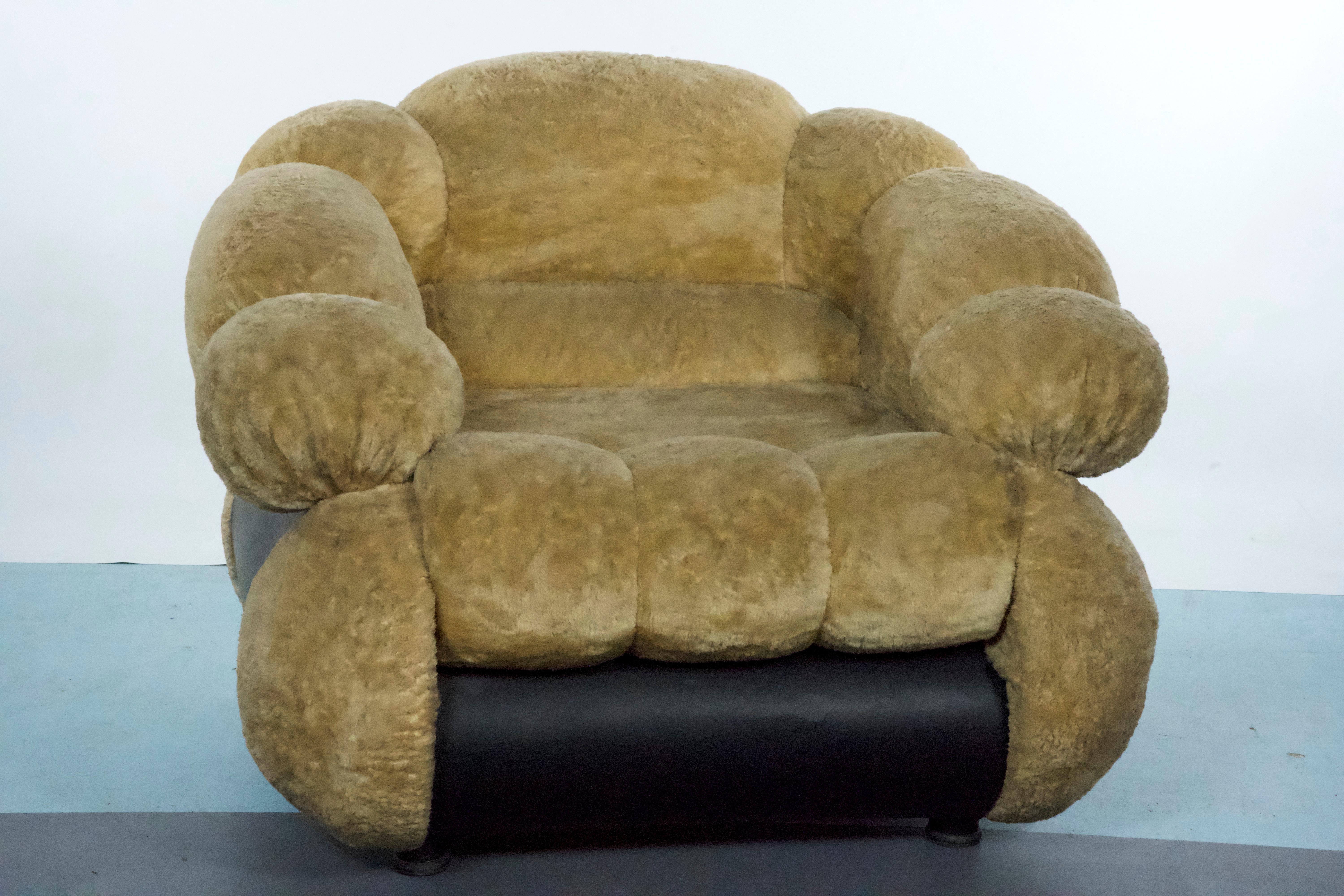 A rare single armchair designed by Adriano Piazzesi, produced in Italy during the 1970s. Upholstered in its original cream teddy bear fabric and black leatherette, this piece embodies the bold, futuristic style of the Space Age era.
In good vintage