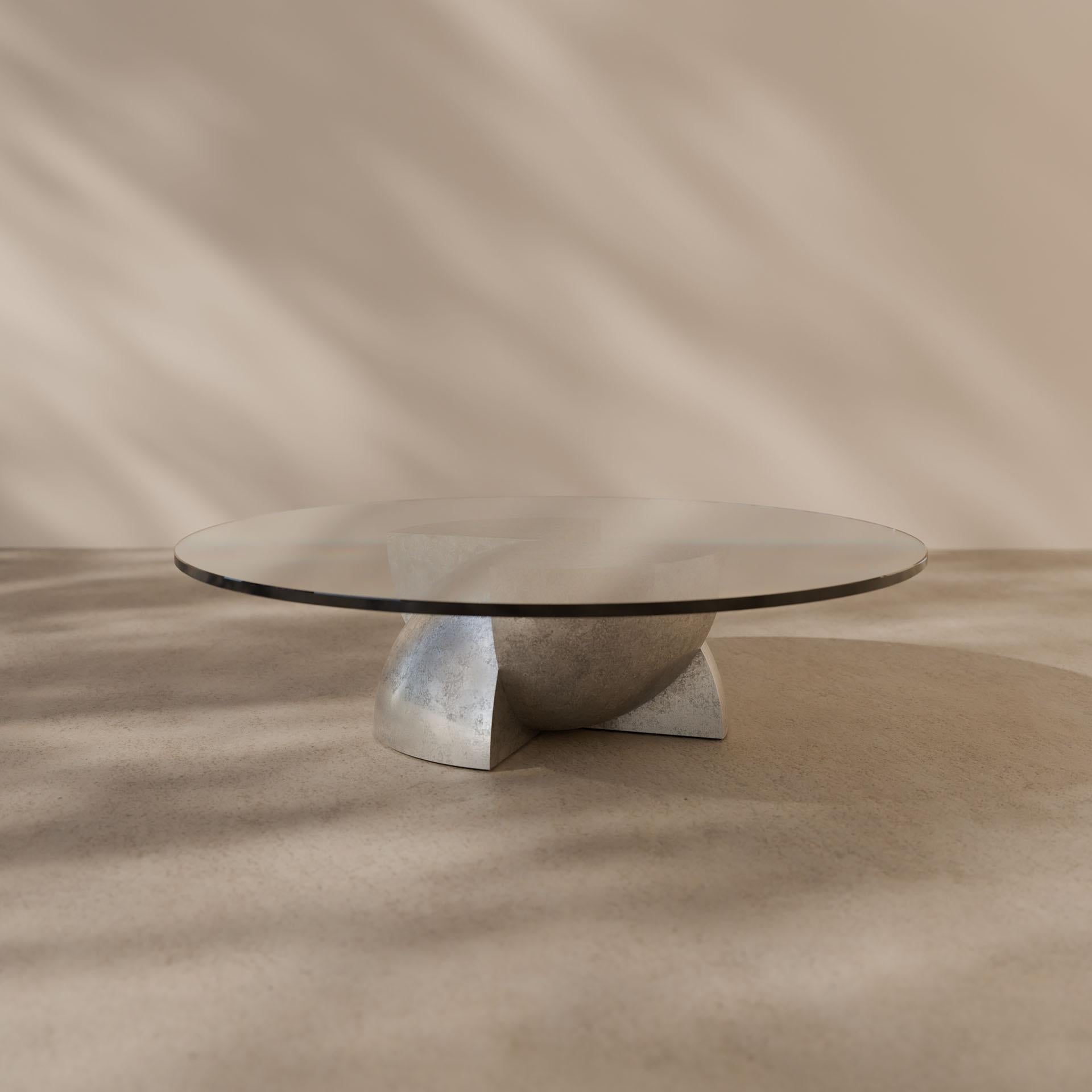 The Axis coffee table draws inspiration from the concept of superposition, where multiple states exist simultaneously. Its design features a clear glass surface supported by a solid base divided into four distinct quadrants.

This unique structure