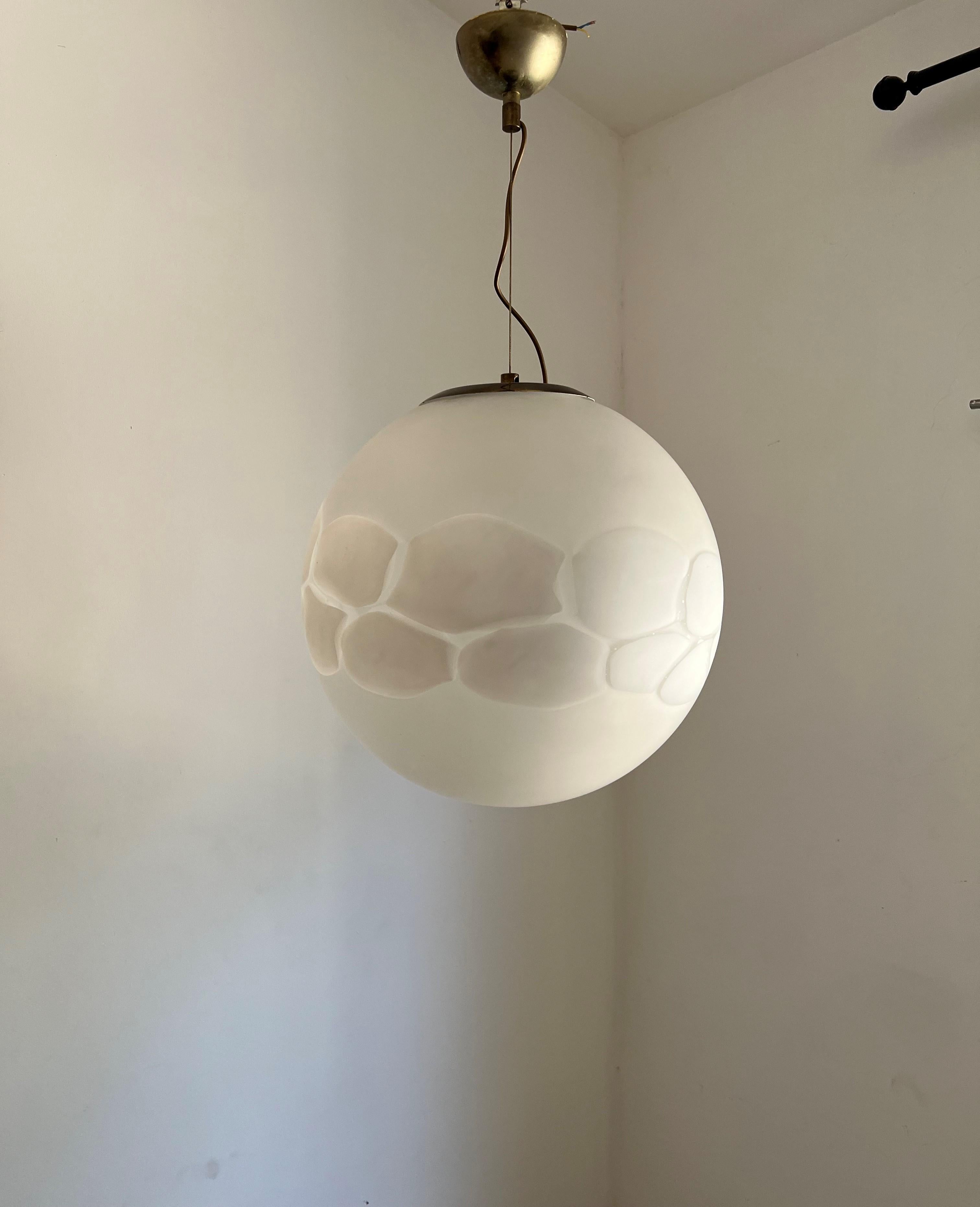 Space Age pendant light manufactured in white and clear hand blown Murano glass, in the style of Mazzega, circa 1970.
This is a very large sphere measuring 46 cm in diameter. (lage spheres run around 38-40 cm)
Height is 80 cm but can be easily