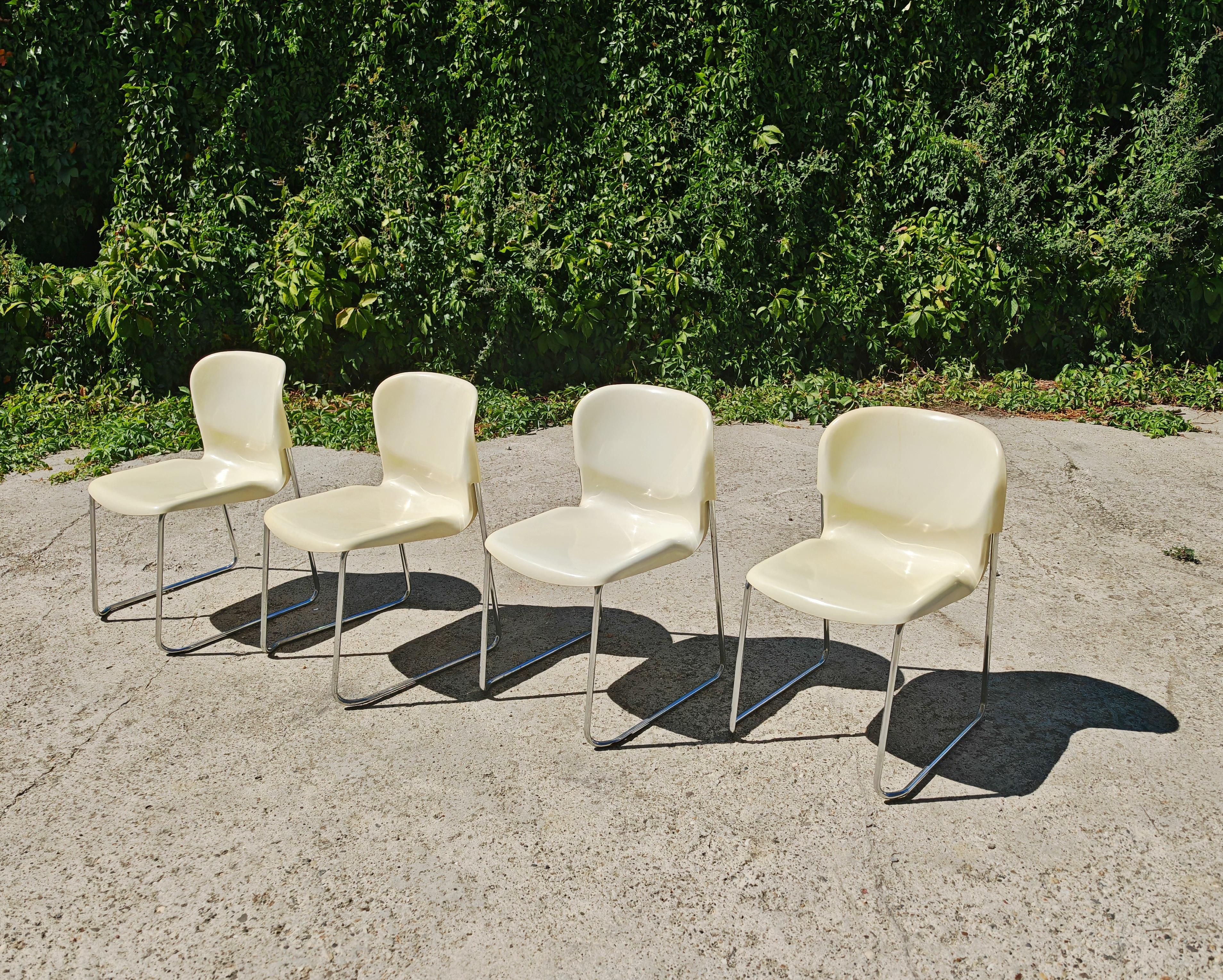 In this listing you will find Space Age Stackable Swing Chairs, Model SM400 K designed by Gerd Lange for Drabert. The chairs are done in off-white plastic, with the steel legs. The manufacturer's stamp is engraved in the back of the chairs, with the