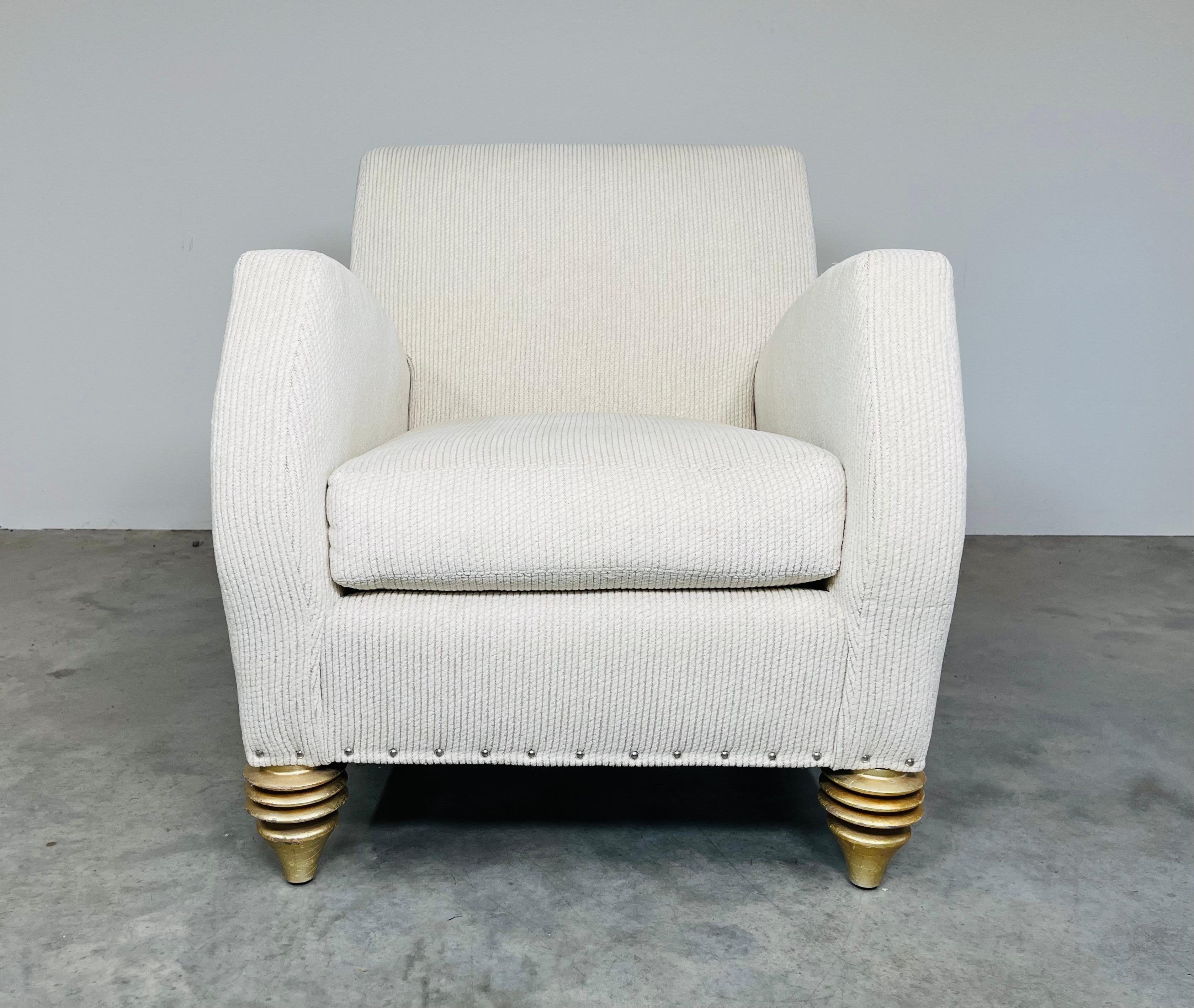 A beautiful and incredibly comfortable club chair having raised armrests and plush cotton/poly upholstery over gold space age style turned legs designed by Larry Laslo for DIRECTIONAL. 
In outstanding and very clean condition with bouyant cushion