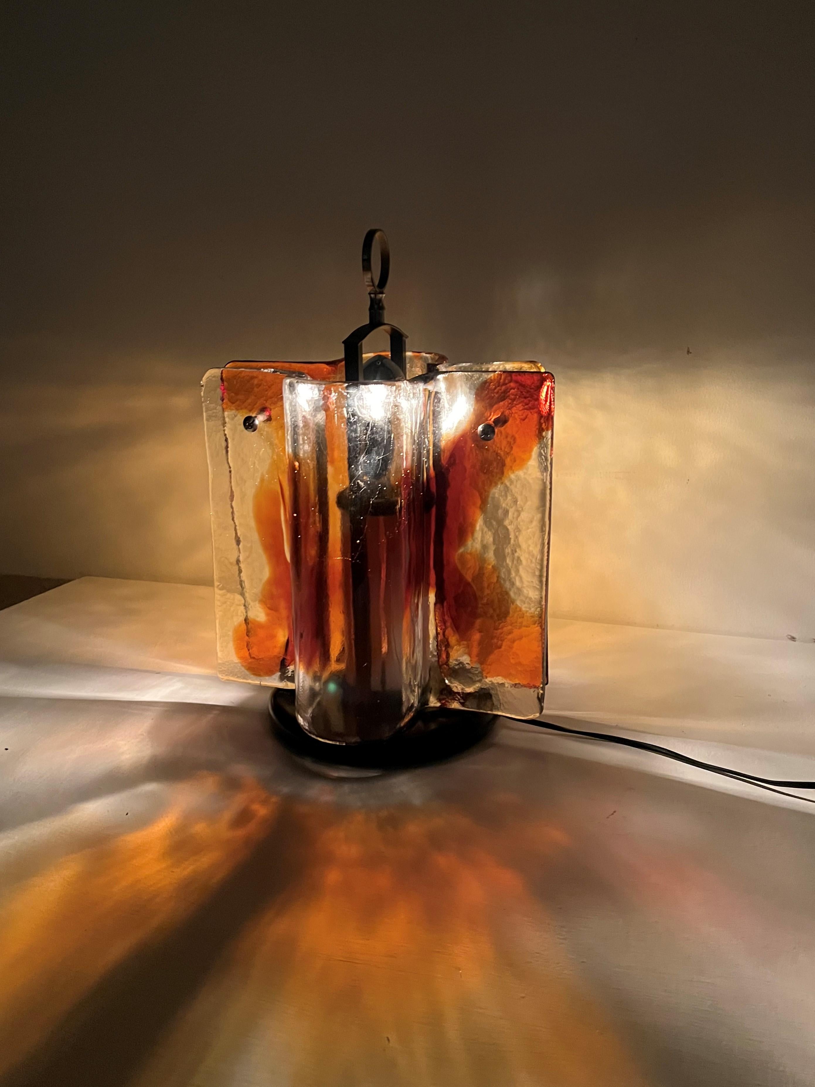 Space age table lamp attributed to Designer Toni Zuccheri for the Venini glass factory in Murano Italy circa 1970.
The lamp casts a beautiful mixed light as can be appreciated in the photos and it consists of 2 large slabs of clear and amber glass