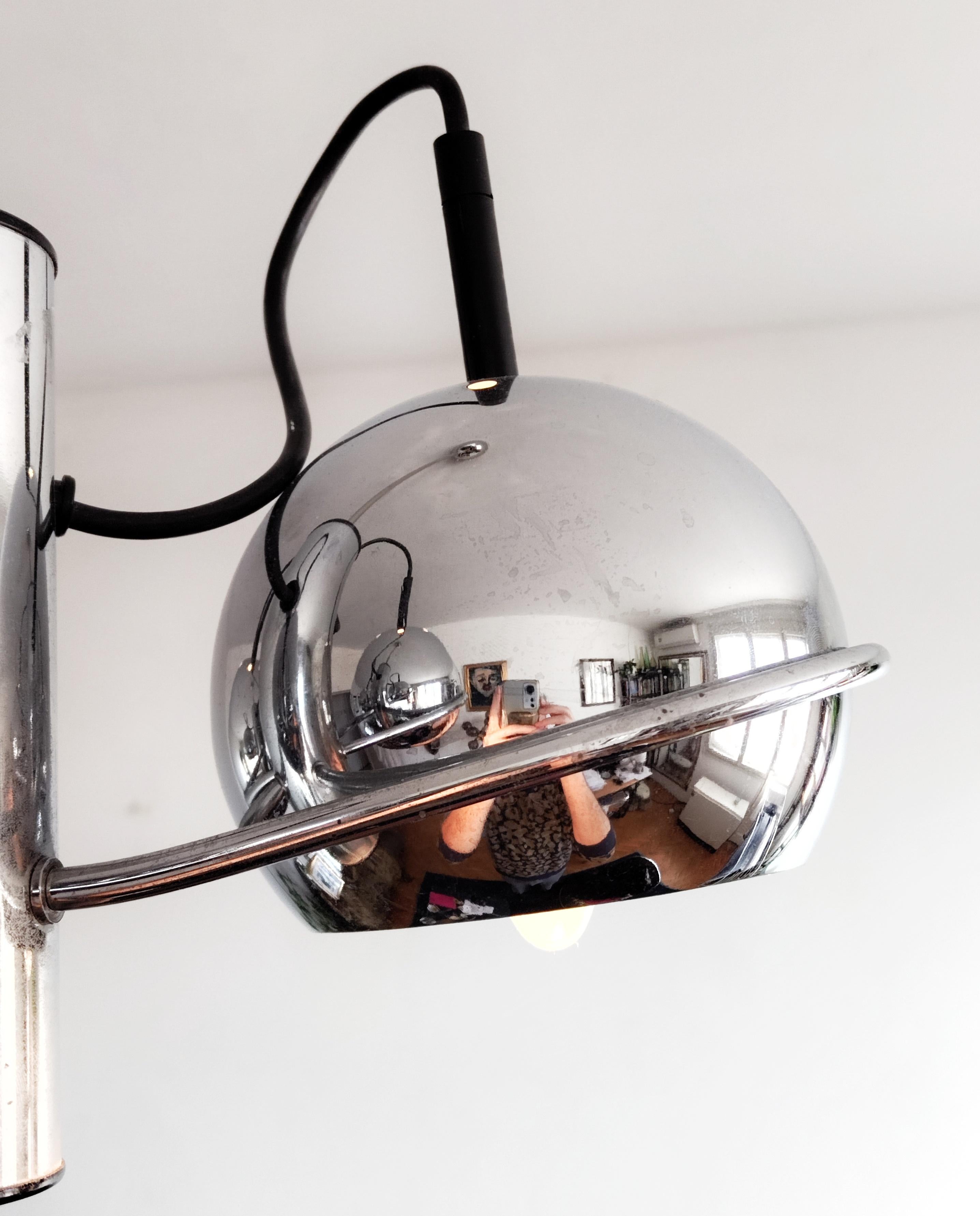 Wonderful hanging lamp made of chromed aluminum in the 60's in Italy. The vintage ceiling lamp is formed by a central stem in chromed aluminum in silver color. The lights are hidden within the 3 eyeball shaped shades and are positioned under a