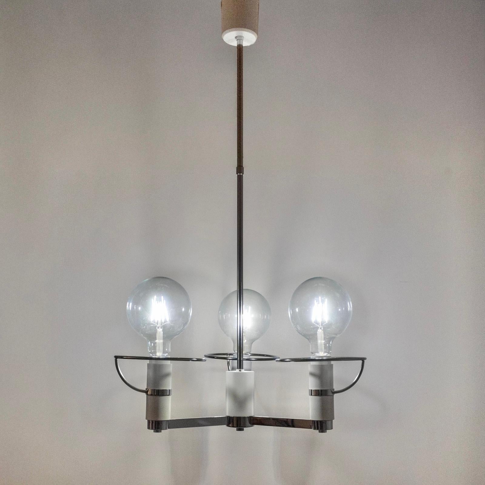 Space Age Three-Light Chromed Chandelier, Italy, 1970s.

Unsual chandelier manufacture in Italy that blends the elegance of classical lighting with the bold, futuristic aesthetics of the Space Age movement. 

Featuring a sleek chromed metal