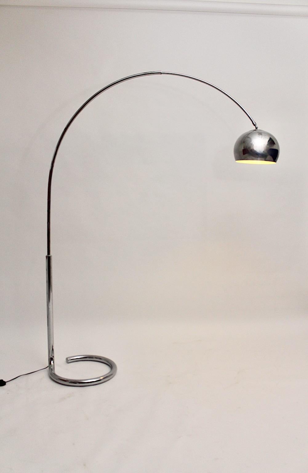 Space Age vintage chromed metal floor lamp with a curved base and a telescope arm from 1960s, Germany.
While the telescope tube arm is adjustable and swiveling, the lamp shade from chromed metal shows a beautiful shape and is movable, too.
Very