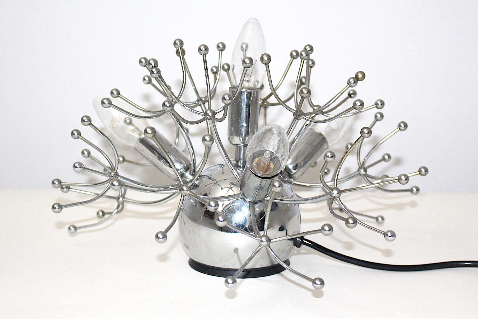 Lampada da tavolo vintage Space AGE in metallo cromato color argento di Sciolari 1960, Italia.
Questa futuristica lampada da tavolo in stile Sputnik, di colore argento, presenta quattro ( 4 ) prese E 14 e un interruttore on/off sul