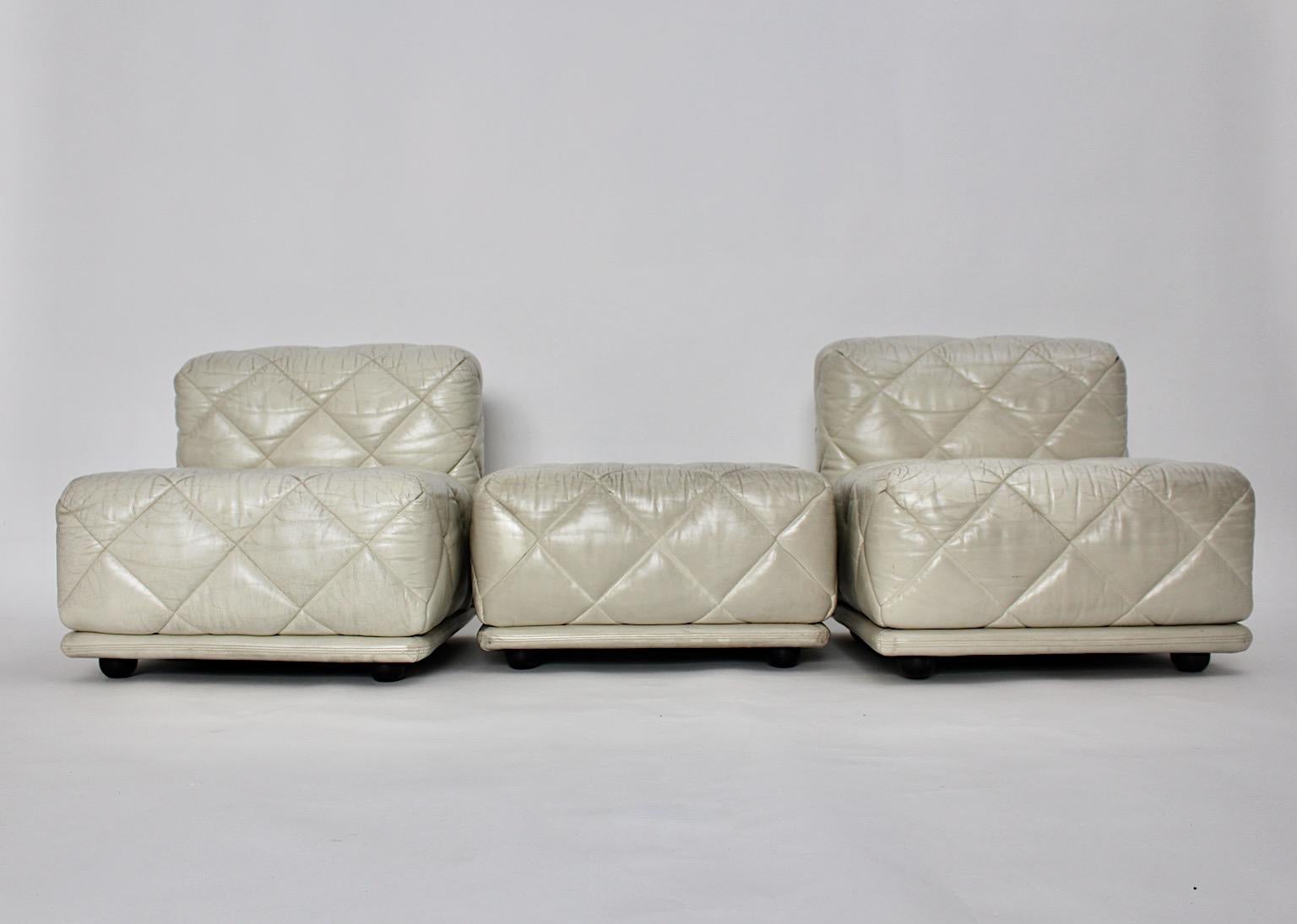 Space Age vintage sectional two lounge chairs with one stool from leather in ivory color tone 1970s by Wittmann Austria.
The very comfortable settee model Rhombos features stitched leather in butter cream color, which flatters to each