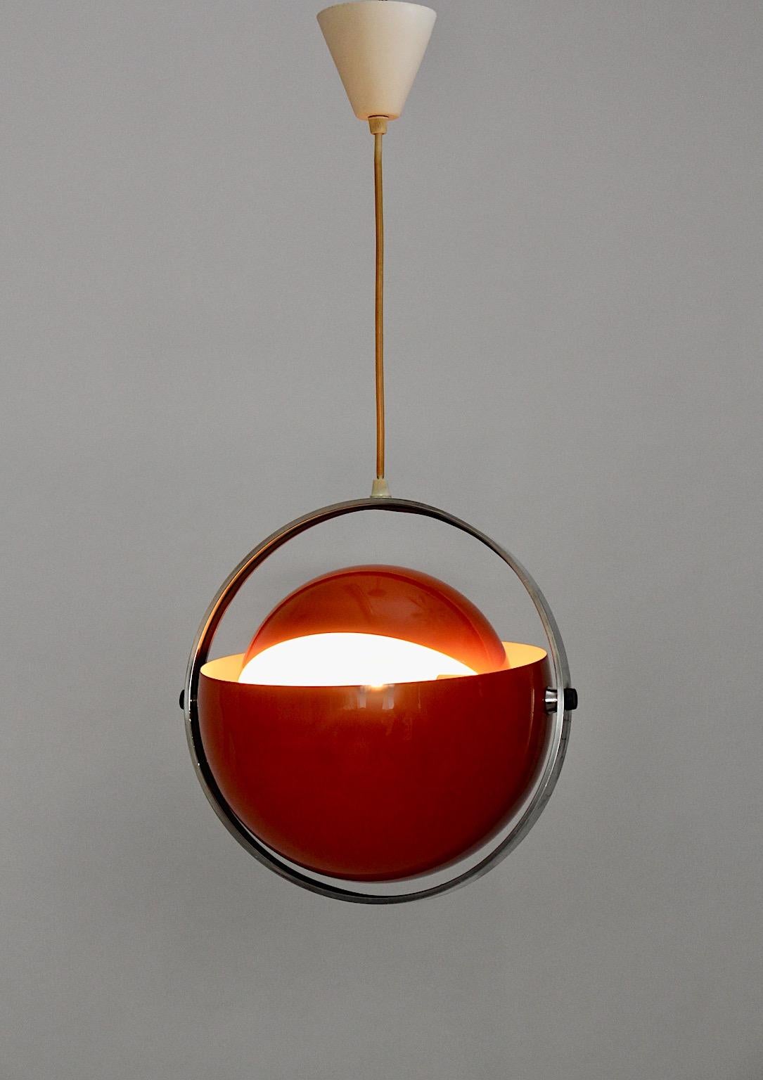 Space Age vintage chandelier or pendant model Moon designed 1970s Denmark by Flemming Brylle & Preben Jacobsen from metal in lipstick like orange coral color tone with ivory colored interior.
An amazing pendant in beautiful red color tone.
The