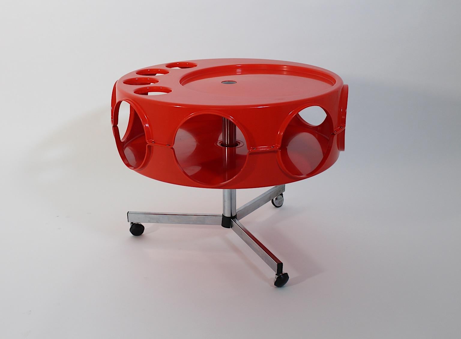 Chariot de bar ou table de canapé vintage de l'ère spatiale Rotobar par Curver en plastique de couleur orange circa 1971, Pays-Bas.
Un nouveau venu audacieux et joyeux, le chariot de bar à roulettes avec 4 ( quatre ) incrustations pour récipients ou