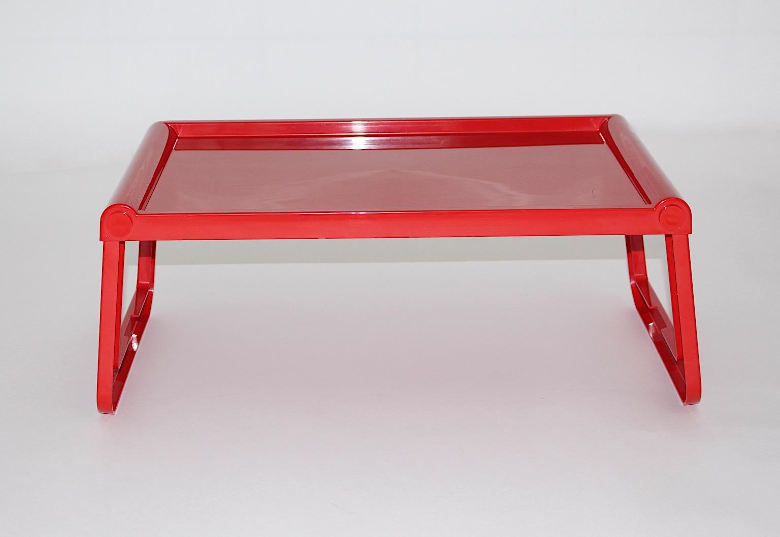 Space Age vintage plastic tray table or gueridon or foldable breakfast table model Pepito designed by Luigi Massoni 
Grafico Studio Zeto for Guzzini italy 1970s.
Very practical to use it as laptop table or breakfast table.
Made from red ABS