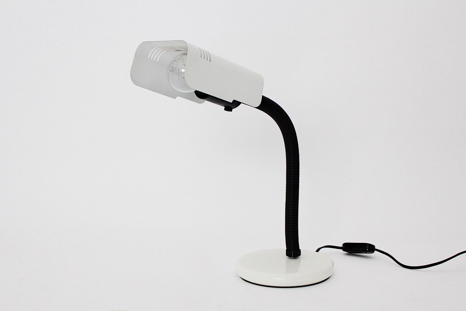 Space Age vintage table lamp desk lamp by Targetti 1970s Italy.
The desk lamp shows black flexible tube arm and white lacquered metal base and shade.
On / off switch. One E 27 socket
Company name is labeled underneath
Very good condition with