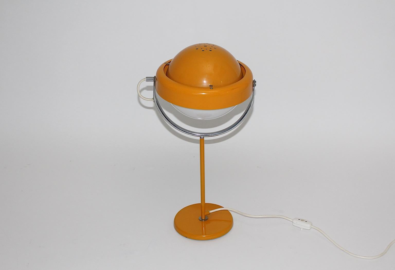 Space Age vintage orange or yellow table lamp from metal by Uno Dahlen
for Aneta 1960s Sweden.
A joyful and powerful table lamp in beautiful dark yellow or soft orange color with an adjustable lamp shade.
Labeled underneath with company's name