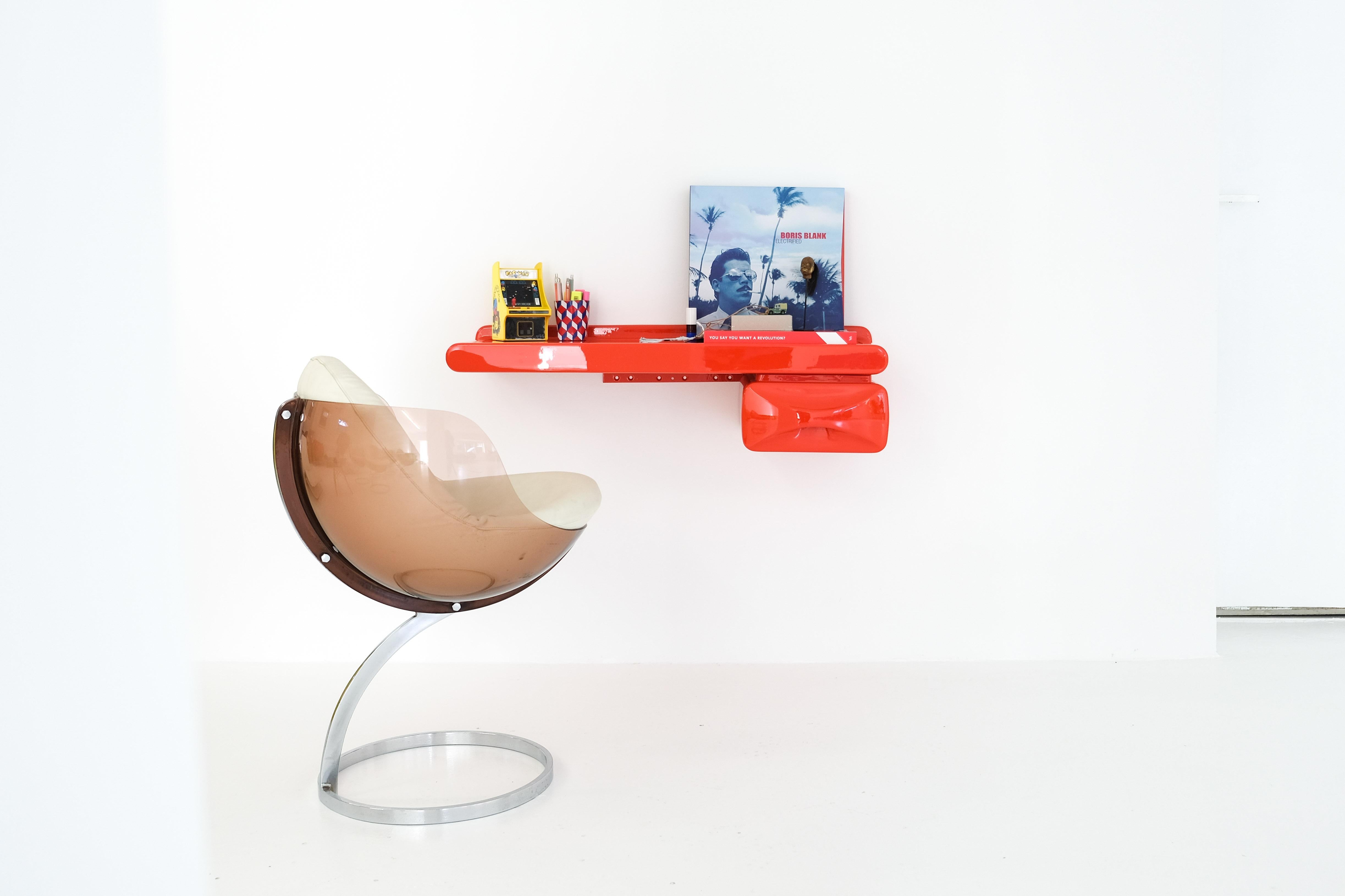 A small, wall-mounted storage board or deskwith a drawer. Newly lacquered in a rich coral red form our car painter. Attributed to Ernest Igl.
