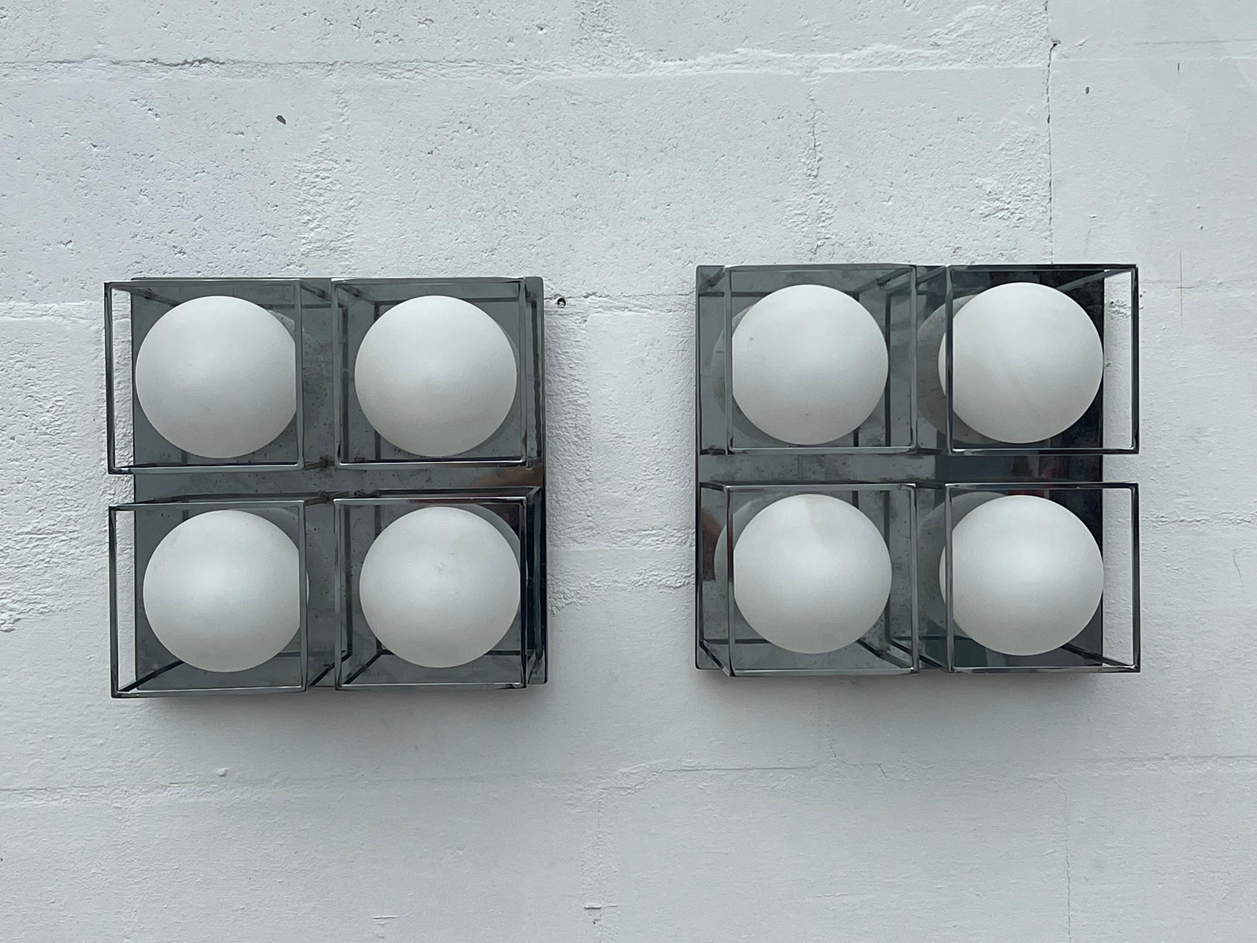 Unusual Italian lights-a pair of sconces or ceiling mount plus a bonus 3 light matching fixture. Heavy chromed steel and satin glass shades. Very space age and futuristic. The exterior dimensions are 13.75x13.75