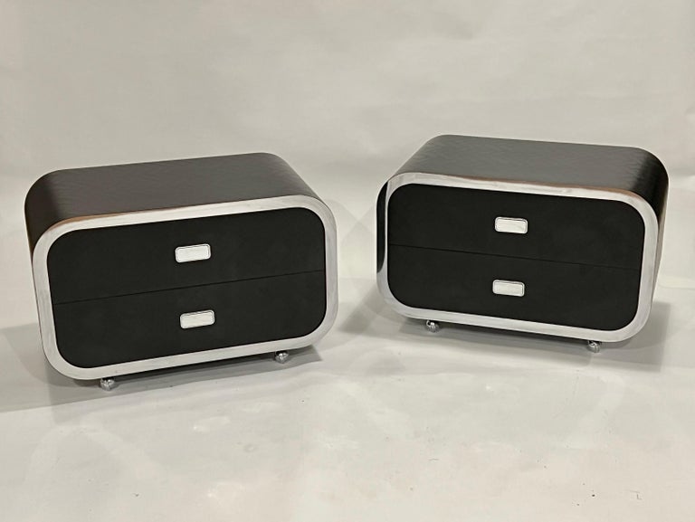 Pair of 1970's waterfall end tables or nightstands in the style of Pace or Karl Springer. Each chest features two pull-out drawers and are crafted in a black brick chevron designed stamped faux hide and chrome piping. Finished on all four sides and