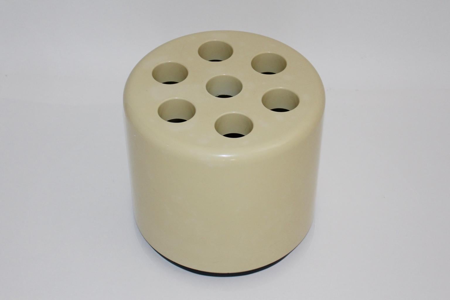 The vintage umbrella stand designed by Roberto Lucci and Paolo Orlandini, 1970s Italy for Velca Legnano Milano. Also the umbrella stand consists of metal, for a good and safety standing, and is coated with ivory white plastic. Furthermore the