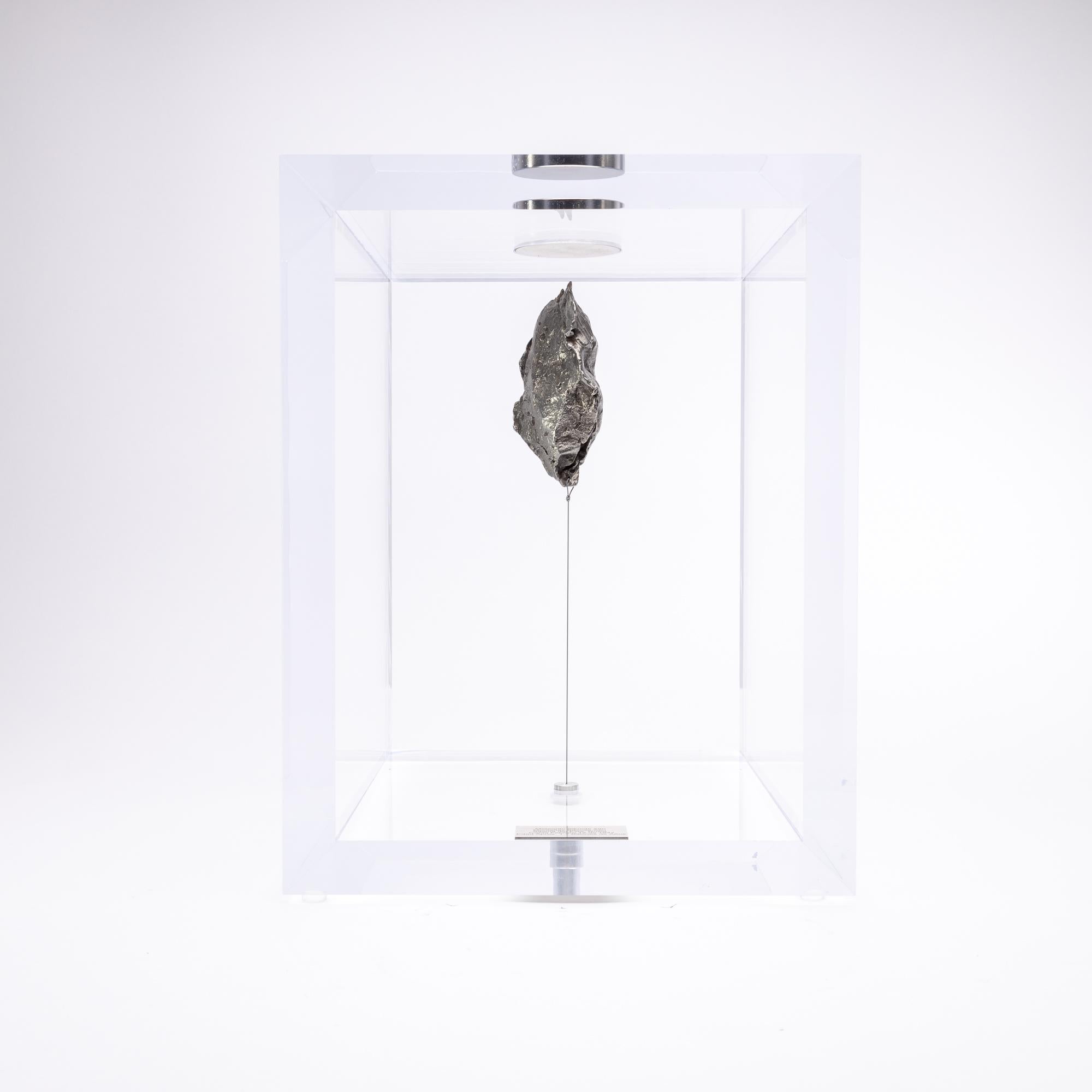 The “Space Box” was designed by Ernesto Duran, as a creative way to enhance the uniqueness of meteorites and could also be used as a decorative piece. It’s an acrylic box with a magnet on top and a steel string pulling the meteorite straight