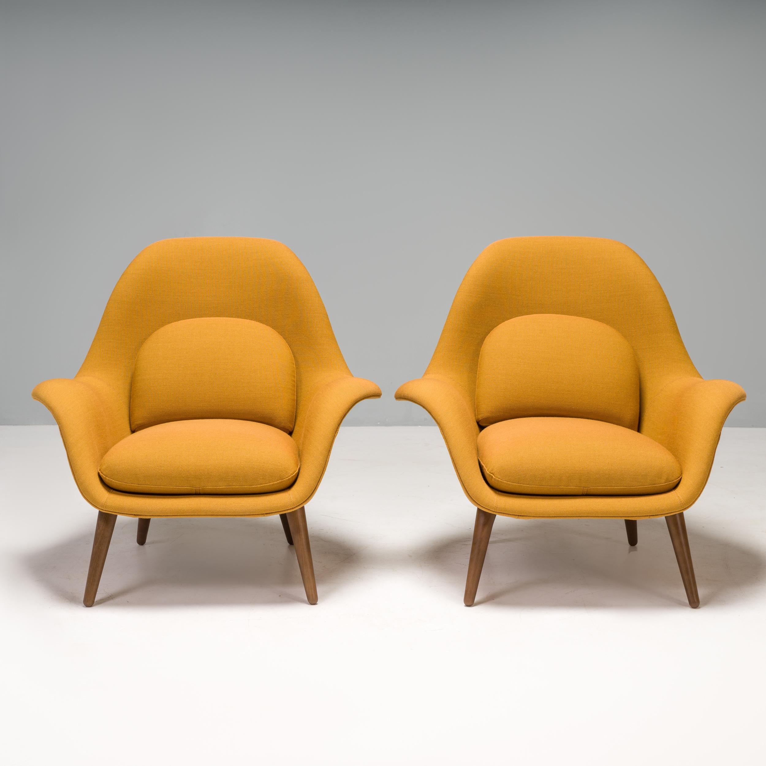 Designed by Space Copenhagen for Danish furniture manufacturer Fredericia, this pair of Swoon armchairs was made in 2021.

Featuring a lacquered walnut frame, the chairs have a sculptural silhouette with a high curved back, giving a contemporary