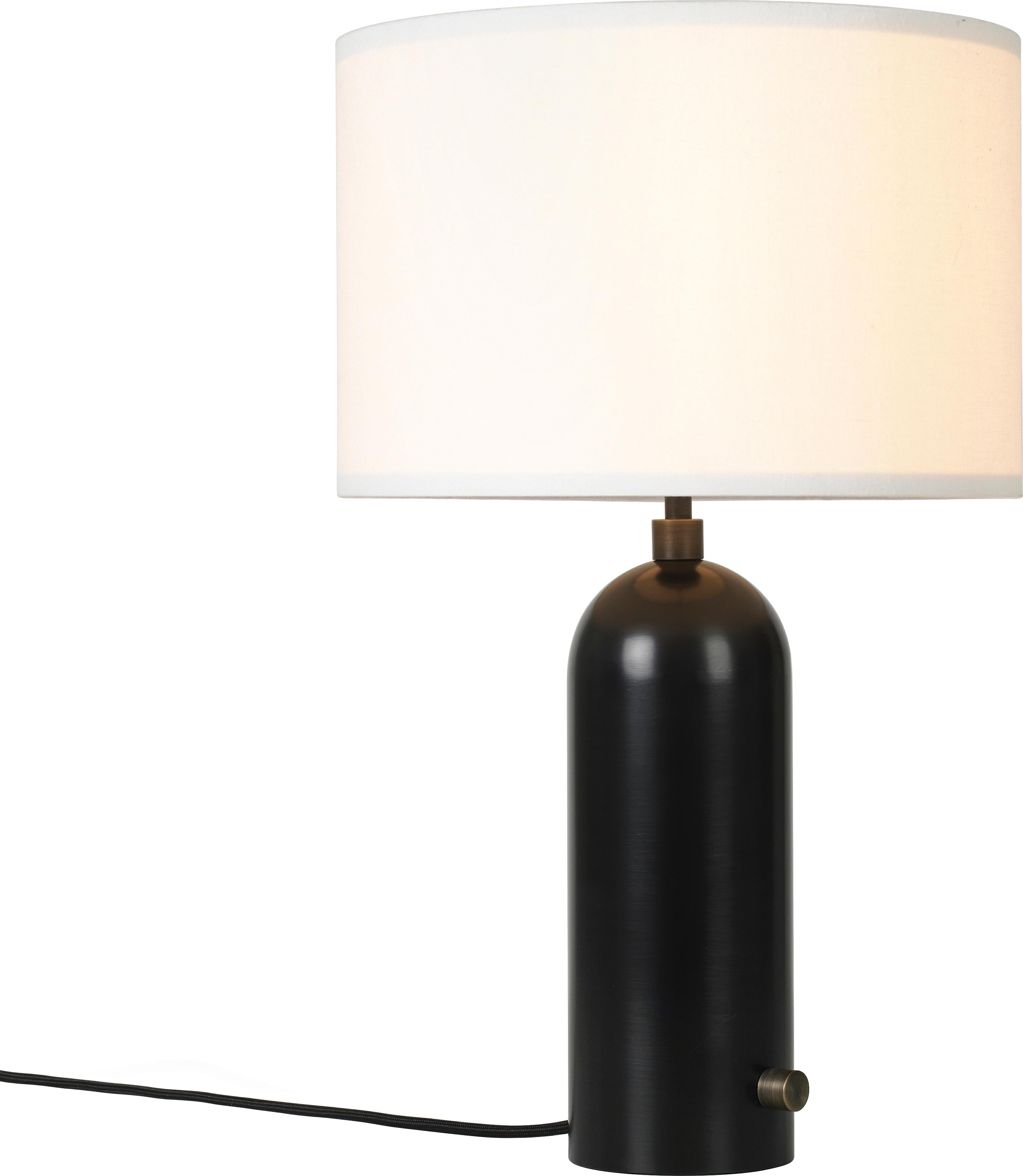 Large 'Gravity' Blackened Steel Table Lamp by Space Copenhagen for Gubi.

Executed in blackened steel with a canvas or white textile shade perched atop its stem, the Gravity table lamp designed by Space Copenhagen for GUBI contrasts strength and