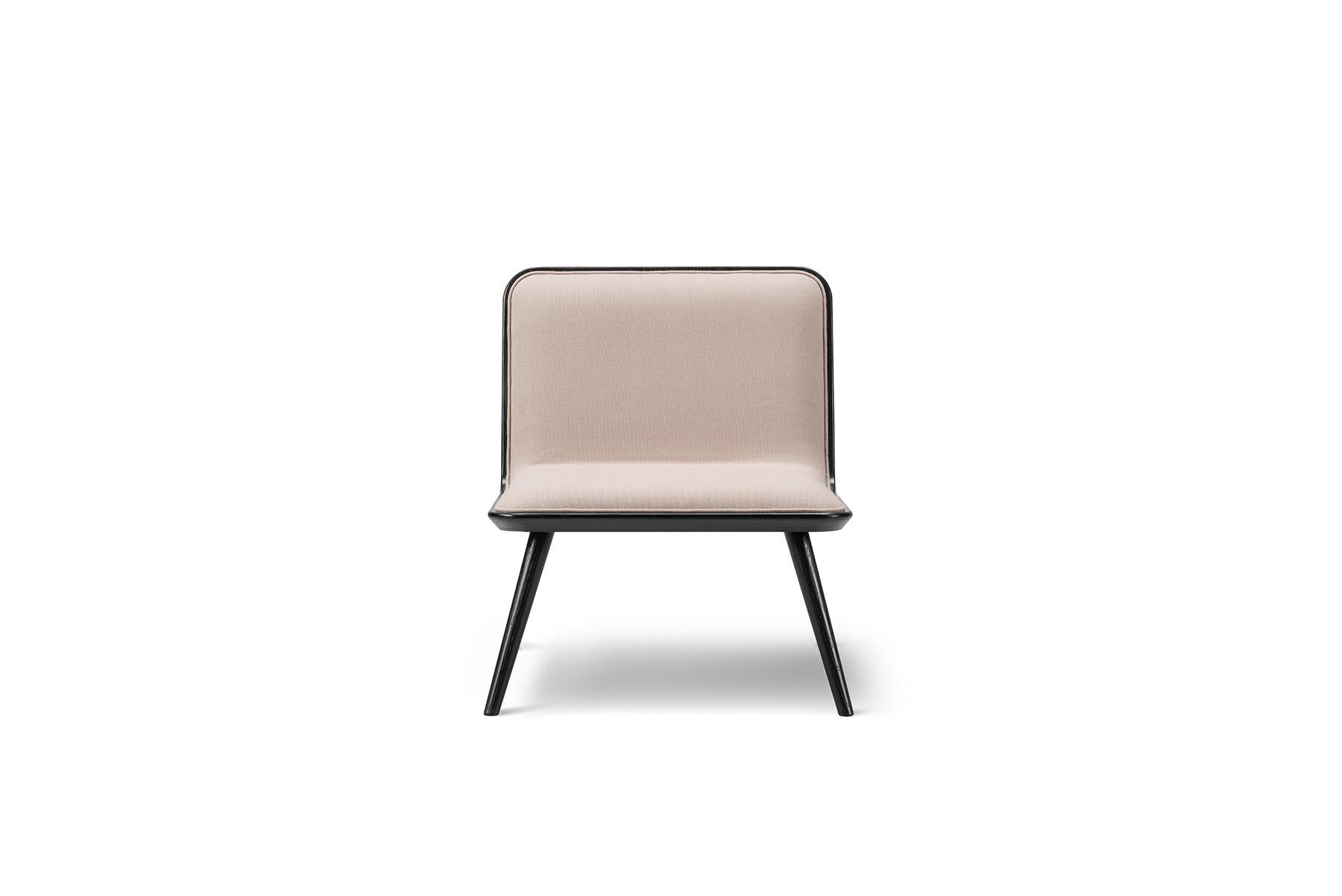 Space Copenhagen spine chair – wood base is a light lounge chair for residential homes or open lounge areas. The accented detailing on the front upholstered seat in leather or textile combined with a back in oak makes the chair as beautiful standing